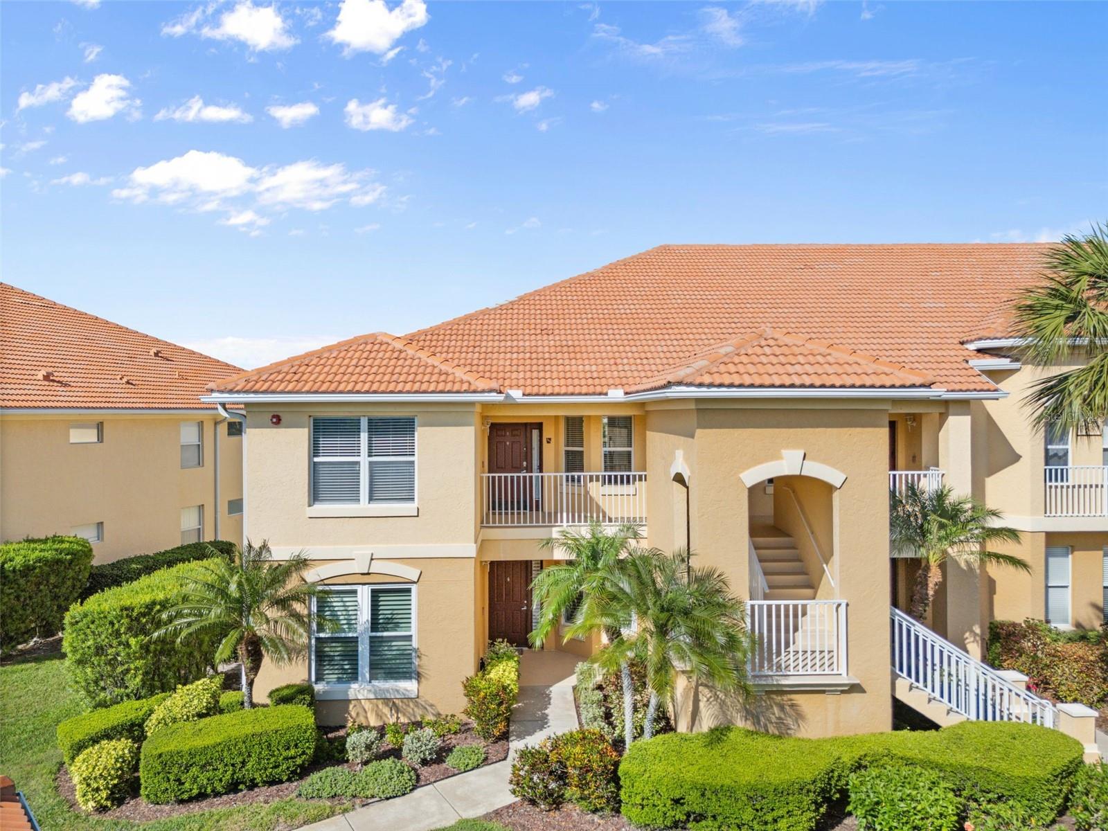 Welcome to 7187 Boca Grove Pl Unit 201! Lovely Golf Course view Lakewood Ranch Condo in gated community. This is a 2nd Floor End Unit 2 bedroom / 2 bath plus Den with Ceramic Tile flooring and Plantation Shutters throughout except for the vertical blinds over the lanai sliding doors.. It also comes with a 1 car garage! The view is of The Legacy Golf Course #6 green and fairway across the lake and the 7th tee. Step into the entry foyer. The guest bedroom, bathroom and laundry room is to your left separated from the foyer with a pocket door that can make it a private guest suite when closed. Just past the Guest area is a Den with French Doors. Could be used for extra sleeping area for guest, or use it as an office space. On the right side of the Foyer is the eat - in dinette attached to the Kitchen with wrap around breakfast bar. This unit is located just 5 minutes from UTC Mall & Waterside in Lakewood Ranch.