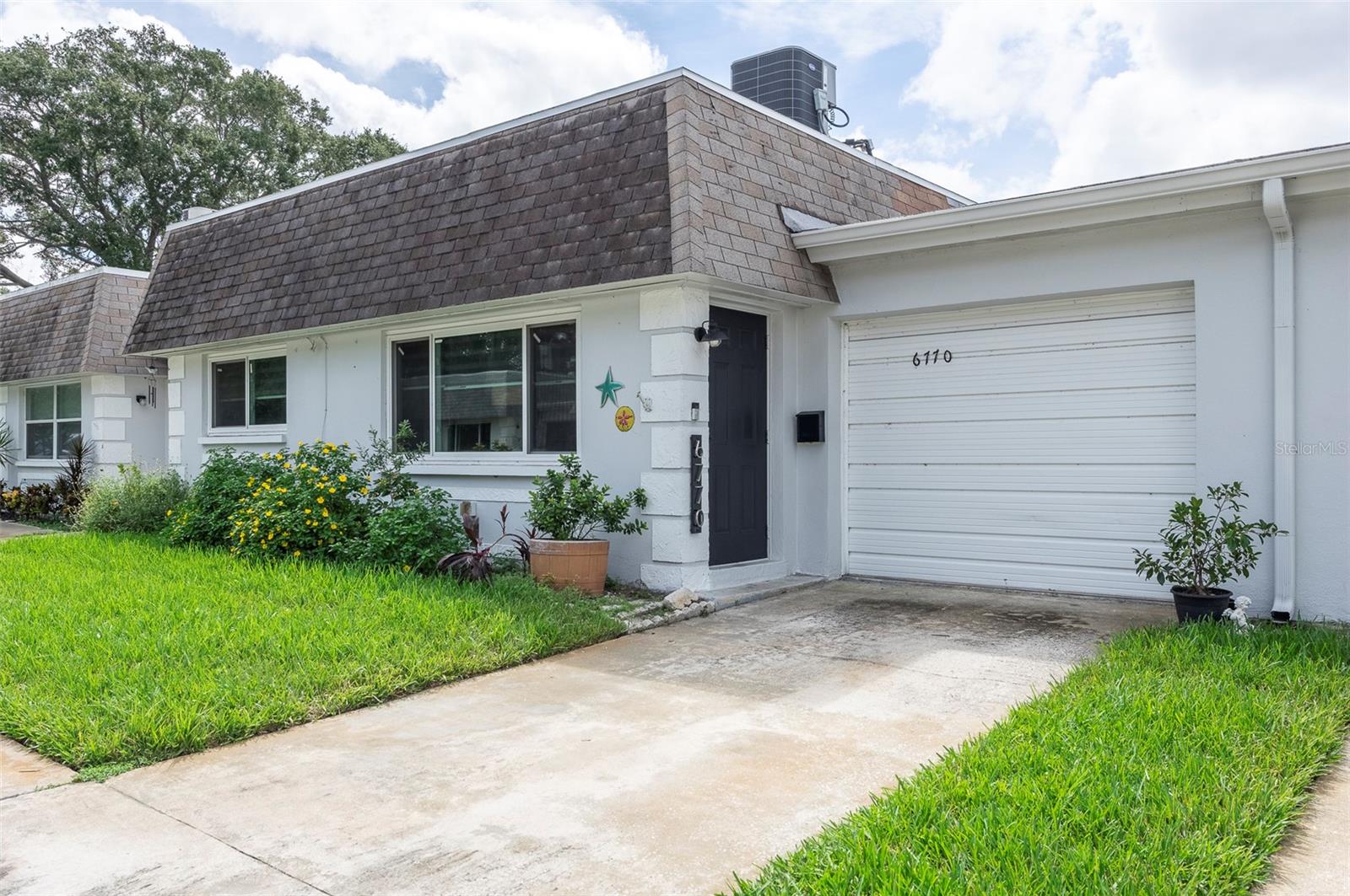 Welcome to this wonderful 55+ community of Vendome Village. Monaco is one of the best streets that dead ends to the conservation district of Joe’s Creek. This prime lot unit offers the peace of not having any rear neighbors, so you can enjoy your morning coffee or evenings on the patio undisturbed. Stroll across your backyard for a quick dip in the pool or a game of shuffleboard. or perhaps join in on the fun in the clubhouse; all just a few steps away. This 2 bedroom 2 bathroom unit, with a full-sized 1 CAR attached GARAGE has a very spacious primary bedroom with a walk-in closet and updated en-suite bathroom. The kitchen has a modern sleek style, with newer STAINLESS-STEEL appliances and gorgeous granite countertops. The newly installed Luxury Vinyl Flooring throughout is not only practical but is stylish and offers easy care and maintenance. You will enjoy the recent upgrades of a NEW Flat Roof (August 2024) New HURRICANE IMPACT WINDOWS (2021), and a recently installed A/C system (May. 2023) with an upgraded feature of a UV air purifier, designed to enhance the air quality. Vendome Village is very close to shopping, restaurants, and the public bus line is within a few blocks that offers convenience to the malls, movie theatres, and the award-winning Gulf Coast Beaches. Easy commute Two airports, Tampa and to wonderful Downtown St. Petersburg.