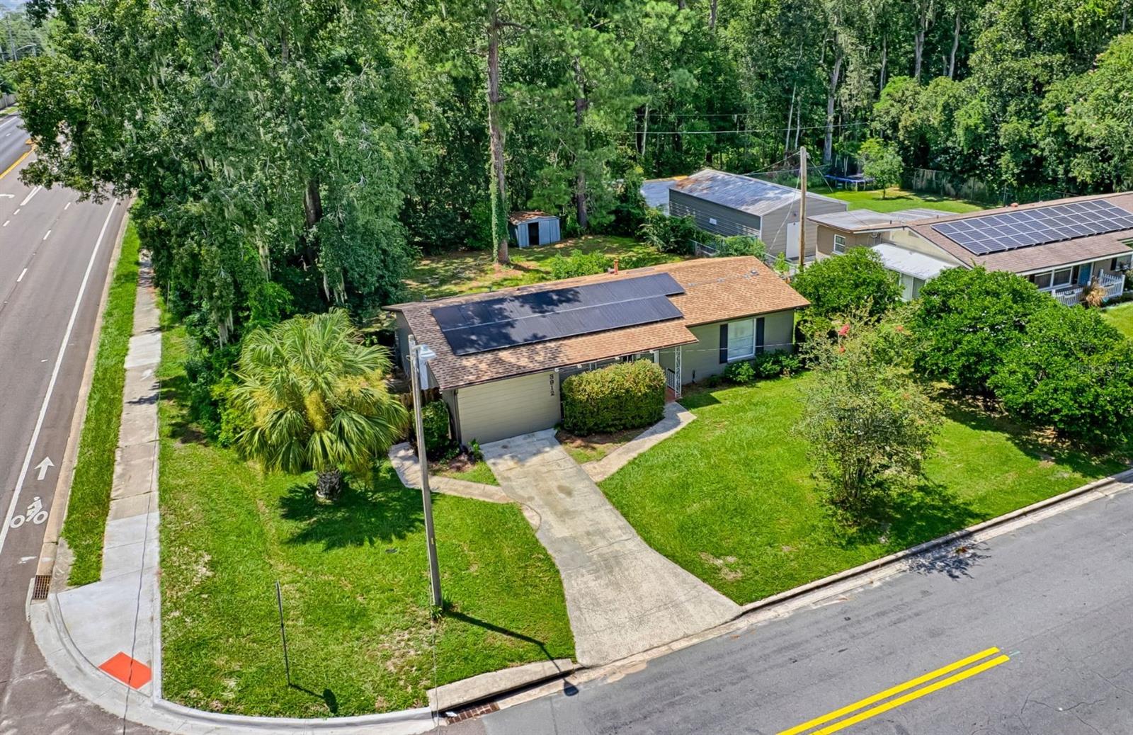 One or more photo(s) has been virtually staged. Welcome to this charming 3-bedroom, 2-bath home in the heart of NW Gainesville — perfectly positioned on a corner lot with only one neighbor and no HOA! Just minutes from top-rated schools, shopping, dining, the University of Florida, and Shands Hospital, this property blends comfort, convenience, and energy savings. Inside, you’ll find a bright, inviting living area, wood-look flooring, and a cozy dining space that opens to a functional kitchen. Both bathrooms are clean and functional, ready for your personal touch. Major updates include a roof replaced in 2023, HVAC replaced in 2020, and paid-in-full solar panels to help reduce monthly electric costs from day one. Enjoy the fully fenced backyard — perfect for pets, play, or entertaining — plus a spacious back patio surrounded by mature trees for added privacy. With its prime location, energy efficiency, and extra elbow room, this home is move-in ready and waiting for its next chapter!