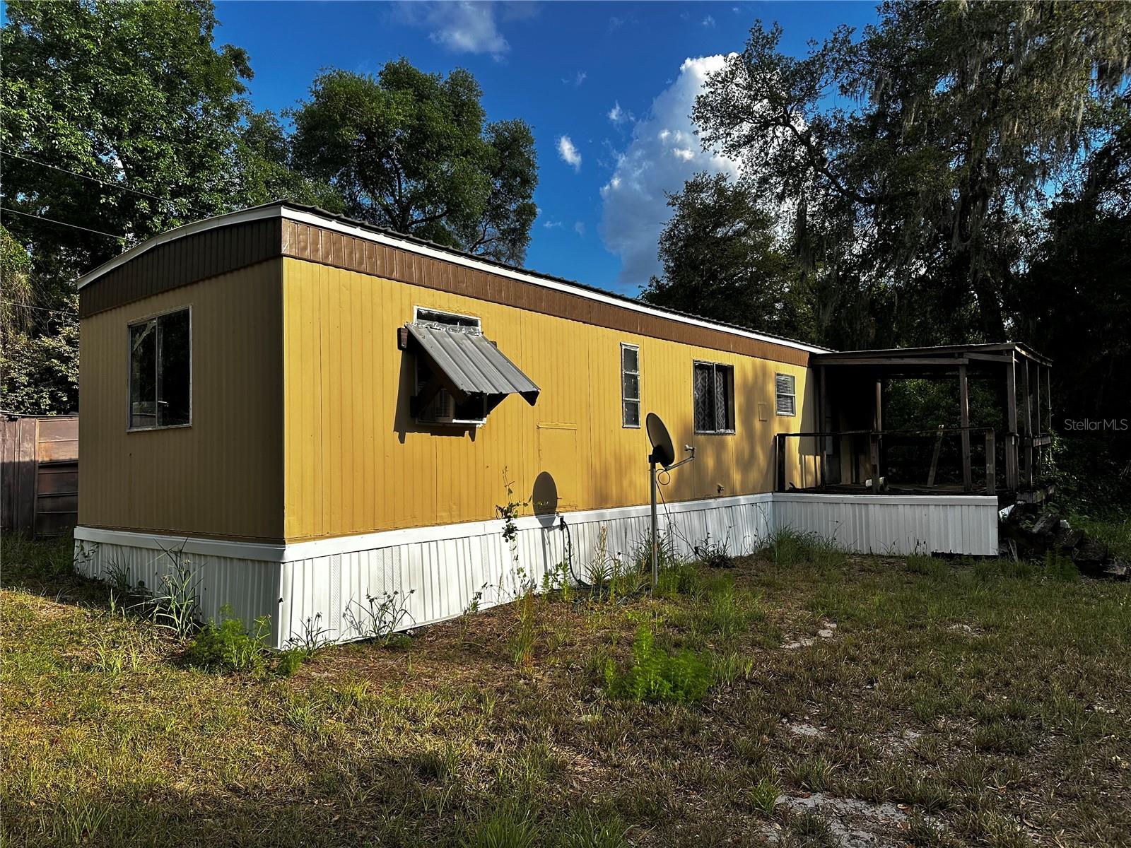 Affordable Forest Getaway with loads of potential. Escape to your peaceful retreat in the Ocala National Forest. This property is ready for your creativity to make it your own. Surrounded by nature and nestled on the banks of Lake Holley this 2 bed 1 bath single wide home is ready for you. Recent updates include new paint, and flooring throughout.
