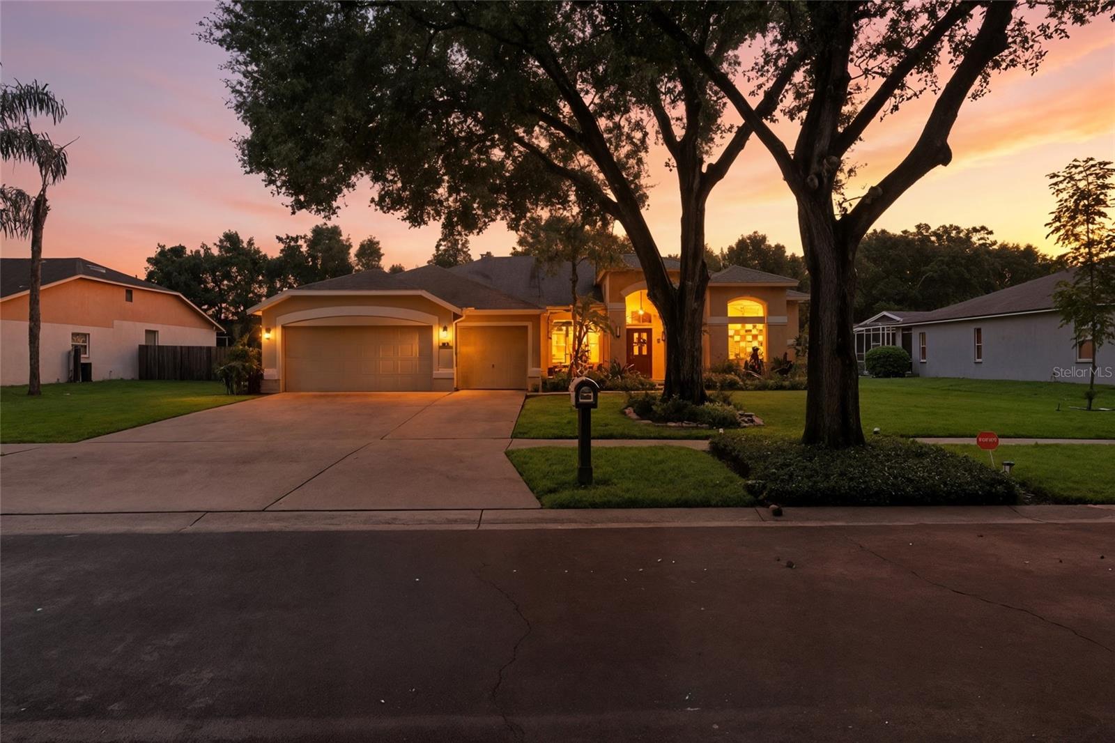 Beautiful and modern South Valrico pool home tucked away in the well established community of Lithia Ridge. Perfectly positioned at the back of the neighborhood with no direct rear neighbors, this stunning residence offers 4 bedrooms, 3 full bathrooms, and a sparkling swimming pool on a spacious .35-acre, fully fenced lot. Lovingly maintained landscaping brings exceptional curb appeal with newer 2023 sod, a butterfly garden, and a variety of vibrant flora. Here you’ll find blueberry bushes, pineapple plants, passion fruit vines, rosemary, lemongrass, bay rum, and even an herb garden! Inside, you’ll find a bright and open floor plan with soaring ceilings, abundant natural light, and modern wood-look tile throughout the main living areas, kitchen, and primary bedroom. Fresh neutral light grey paint (2023) enhances the living areas, kitchen, and master bedroom, while the master bath is accented in a calming light blue. Newer fixtures, vanities, and comfort-height, fast-flush toilets (2024) update all three bathrooms. Mechanical systems are also brand new with a Bosch HVAC (2025) under warranty, a water heater installed in 2024, and there is updated lighting and ceiling fans in the guest bedrooms. For peace of mind, the home includes a Vivint security system with new cameras on the lanai and a front doorbell camera. The elegantly updated kitchen shines with a high-end Bosch dishwasher (2025), French door refrigerator (2022), drawer microwave, and a gorgeous backsplash with tile extending behind the dual oven. The kitchen also features quartz countertops, soft-close doors and drawers, and a separate eating area. The layout flows seamlessly into the great room, creating an inviting space for gatherings and the split-bedroom design provides privacy for everyone. The primary suite includes dual walk-in closets and a luxurious ensuite bath with a soaking tub and walk-in shower. Step outside to your own backyard retreat, complete with a covered and screened lanai, sparkling pool, and generous pool deck, ideal for entertaining or relaxing year-round. Lithia Ridge is a quiet neighborhood with low HOA fees, no CDD, and access to top rated schools. It is also close to shopping and dining options galore, making it the perfect place to call home.