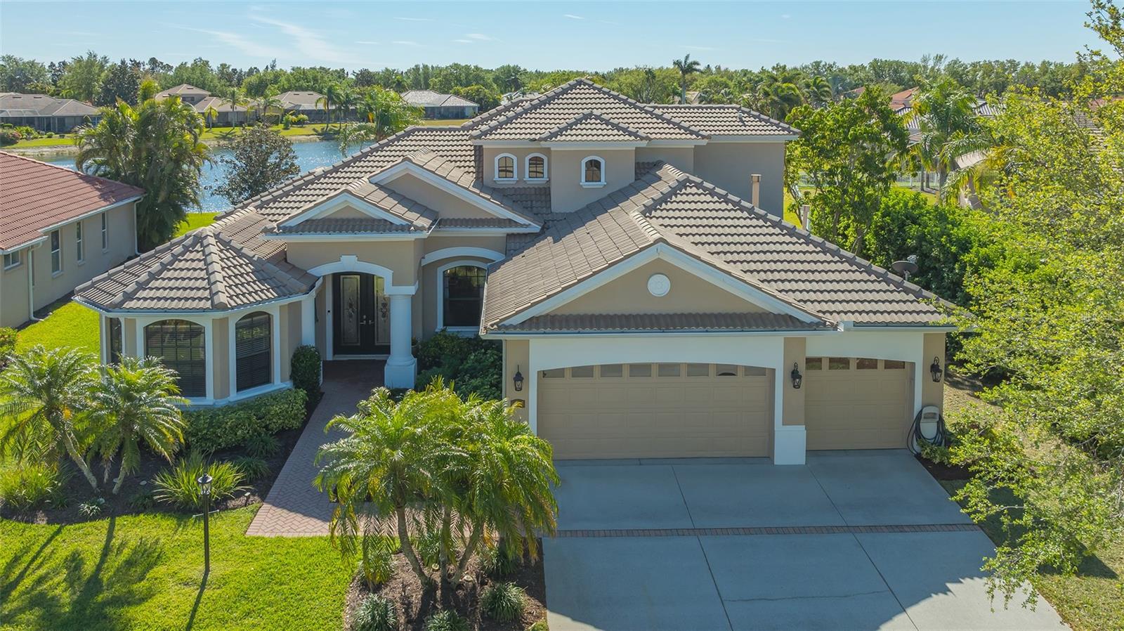 Welcome to this beautifully remodeled and move-in-ready Lee Wetherington home, perfectly nestled in the heart of Lakewood Ranch. Enjoy breathtaking and private views of the serene lake from this thoughtfully updated residence.
Boasting five bedrooms, four full baths, and multiple living spaces, this home is designed for both comfort and versatility. The expansive floor plan includes a formal dining room, butler’s bar, executive office, and a flexible upstairs fifth bedroom—ideal as a bonus room, guest retreat, or in-law suite with a full bath.
The gourmet kitchen has been completely renovated, featuring high-grade granite countertops, a stylish tile backsplash, stainless steel appliances (including range hood, 6-burner gas range, refrigerator, dishwasher, and an in-cabinet microwave), and an oversized island with storage and seating. The stunning soft-close wood cabinetry and large walk-in pantry complete this chef’s dream.
The primary suite is a true sanctuary with two custom walk-in closets, a cozy sitting area, private lanai access, and a completed renovated, spa-inspired bathroom featuring separate vanities, a walk-in shower, and a soaking tub.
Step outside to your peaceful oasis with an expansive lanai with a heated pool and spa, where you can relax and take in the stunning lake views—perfect for entertaining and embracing the Florida lifestyle.
Additional upgrades include: new whole-house generator, new luxury vinyl flooring throughout (no carpet!), new light fixtures, ceiling fans, and LED lighting, exquisite crown molding & tray ceilings, fresh interior paint, and a well-appointed laundry room with utility sink and cabinetry.
Located in Riverwalk Ridge, a hidden gem of Lakewood Ranch, this home is within an A-rated school district and just minutes from Lakewood Ranch Main Street, Waterside Place, UTC Mall, downtown Sarasota, three airports, and world-famous beaches including Siesta Key, Lido Key, Longboat Key, and Anna Maria Island.
This exceptional home won’t last long—schedule your private showing today!