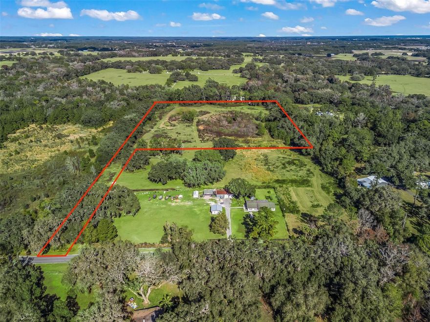 Discover a truly special opportunity to own a beautiful piece of Sumter County countryside, perfectly tucked away along C-44A near SR 44. This exceptional vacant flag-lot parcel features a generous 100-foot-wide private driveway that leads you into a serene and picturesque homesite. Zoned Agricultural, this property invites you to embrace a rural lifestyle—bring your pets, build a horse barn, and design the dream home you’ve always envisioned. Surrounded by other farms and spacious homesites with acreage and barns, the setting feels peaceful and open while still being incredibly private. Enjoy easy access to SR 44 and I-75, placing you just a short drive from Wildwood, The Villages, and Ocala. Experience the best of both worlds: nearby shopping, dining, and entertainment, then return home to your own private retreat where nature and tranquility take center stage.  For those seeking even more space and versatility, this vacant land may be purchased in conjunction with the neighboring homesite, creating an impressive 20-acre estate. The adjoining property includes a 3-bedroom, 2-bath concrete block home, a 24’ x 40’ concrete block office/storage building, a 24’ x 49’ three-bay carport with an 8’ x 24’ workshop, and a 10’ x 14’ utility shed, perfect for equipment, hobbies, or gardening needs. Buy just the vacant land or buy it all. The possibilities here are truly endless. This is a rare chance to secure acreage, privacy, and convenience in one remarkable property. Seller has a survey.