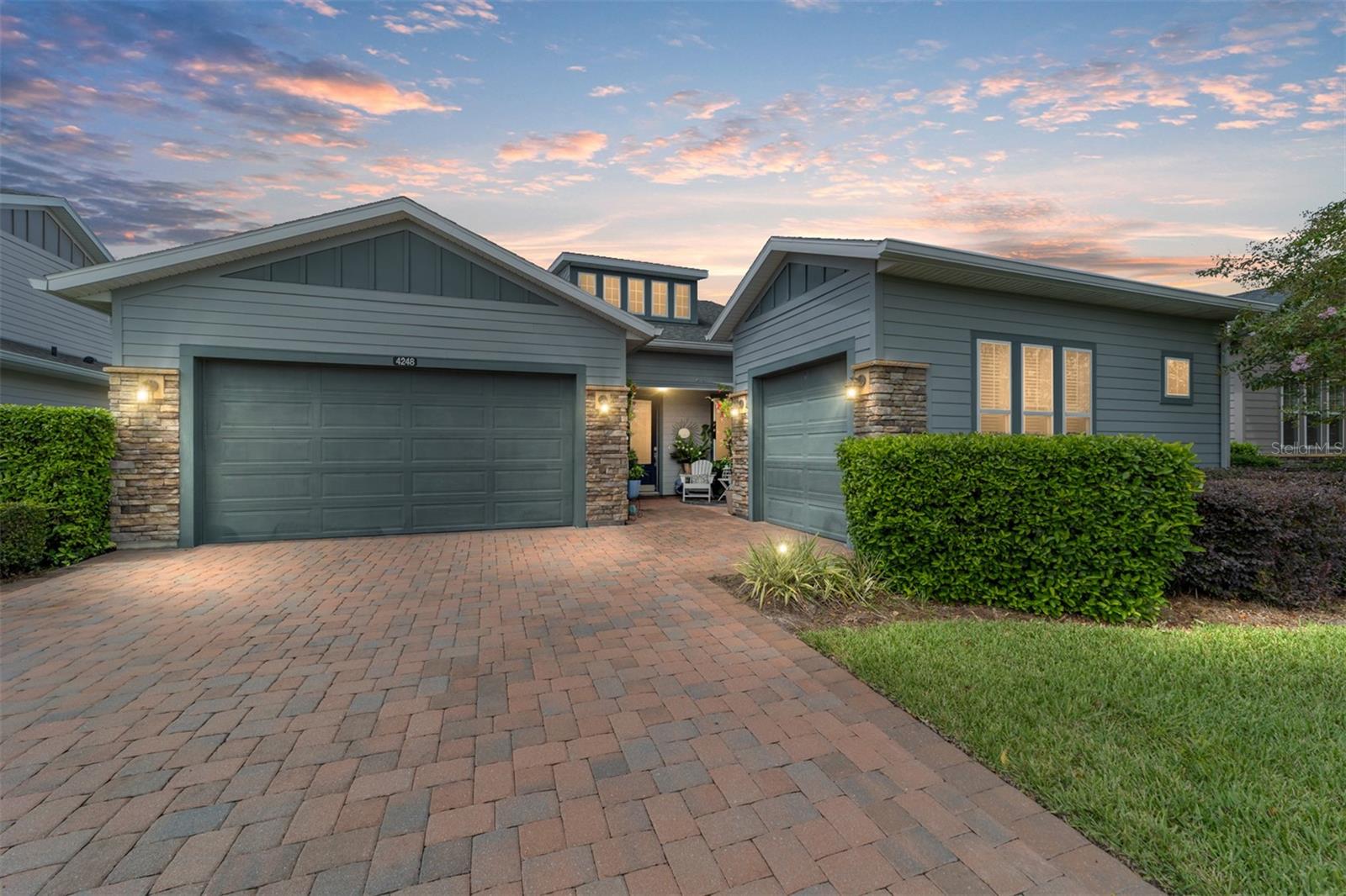 Minutes to WEC/HITS- Welcome to Ocala Preserve, where luxury living meets resort-style amenities just minutes from the World Equestrian Center. This beautifully upgraded Imagine floor plan, Shea Built Home: offering over 2,200 square feet of spacious living with two bedrooms, two and a half bathrooms, a versatile den or office that can be a third bedroom, and a three-car garage perfect for storage, a golf cart, or the workshop you’ve always wanted. Currently the third car garage is being utilized as a workshop.
From the moment you step inside, you’ll notice the attention to detail and over $100,000 in upgrades. The stunning chef’s kitchen is a true showpiece with granite countertops, full island with cabinets for storage throughout, custom shelving, and a built-in wine bar, creating an inviting space for entertaining family and friends. The spacious great room flows seamlessly to the newly designed extended patio, built for both spa and birdcage, along with a fully enclosed porch for year-round enjoyment. Additional highlights include crown molding at the cabinetry, extended SmartSpace in the laundry room, upgraded granite countertops in the owner’s suite and guest bath, and a tray ceiling in the primary bedroom. Walking through the front door, you’ll find a private hallway leading to a spacious guest bedroom with its own full ensuite bath, offering comfort and privacy for visiting family and friends.
Ocala Preserve is one of the area’s most desirable communities, offering a gated lifestyle with golf, fitness, 7-acre lake with kayaking and fishing -Miles of walking, biking, and hiking trails -Three themed parks across 600+ acres -Two luxury resort clubs -Tom Lehman-designed golf course -Resort-style pool and separate lap pool and social events right at your doorstep—all while being less than five miles from the World Equestrian Center. This gorgeous home combines modern upgrades, timeless style, and an unbeatable location. Call today to schedule your private showing.