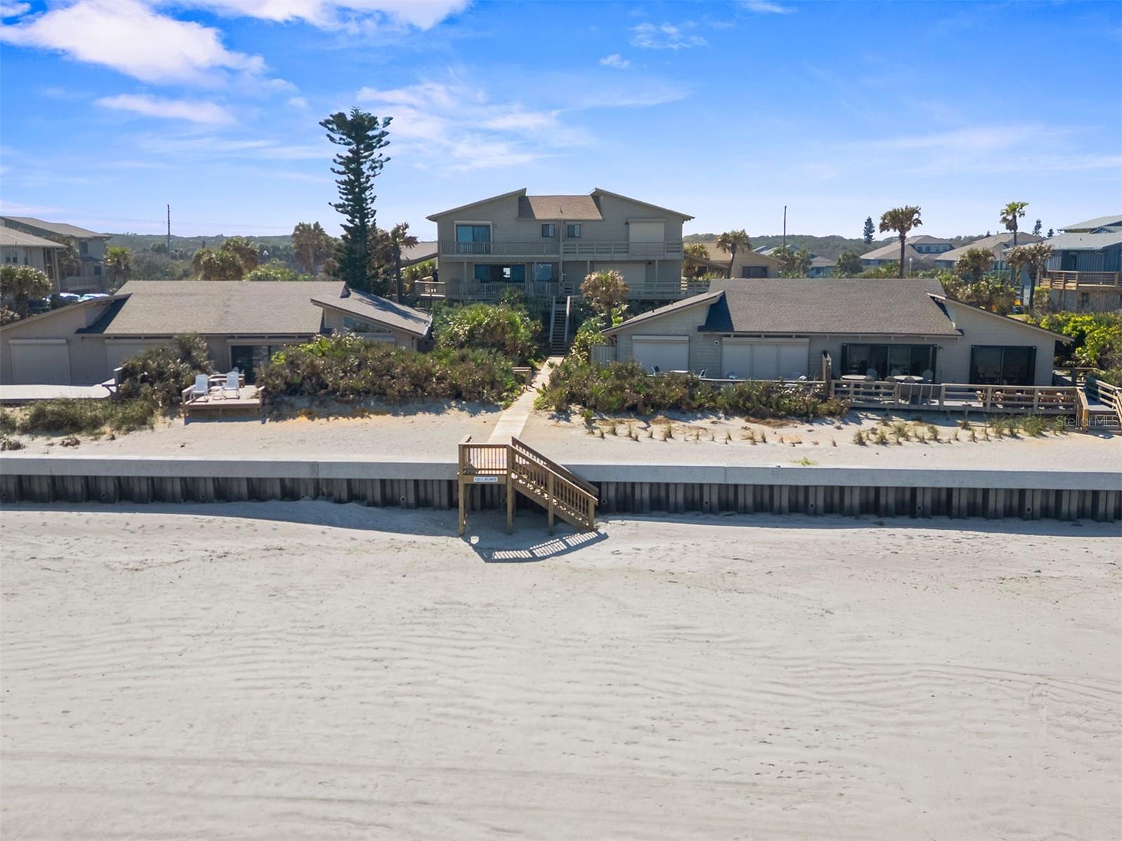 Words are inadequate to fully describe this Spectacular, Ocean Front home on New Smyrna Beach's highly desirable NO-DRIVE BEACH.
Be sure to check out the photos and virtual tour to see it for yourself! With over 2,100 (+/-) sq. ft., Dolphin C-10 is one of the largest residences in all of the Sea Dunes Community, and one of only two "C" floor plan townhouses located in the typical and highly coveted "B" location. If you are not familiar with Sea Dunes, this means C-10 sits right behind and between the one story "A" units, and offers Full Ocean-Front Views. The Dolphin Association is comprised of ten residences that share a private beach access, pool and tennis court. Dolphin C-10 Offers 5 spacious Bedrooms and 4 Full Bathrooms. This is a very unique opportunity to own a very special beach-front home. You'll approach residence C-10 from a wide staircase (with composite planks) onto a gracious wrap-around Ocean Front porch/deck. As you enter the main living level you are immediately welcomed into an elegant, warm coastal vibe. Vintage Pecky Cypress accents capture the vibe of "Old Florida." The Open Floor Plan, High Ceilings and Spacious Living Areas provide all the modern conveniences. In addition to the ocean front great room, the main level offers a spacious dining area and a beautiful kitchen with high-end stainless appliances and laundry. You'll also find a main living level en-suite bedroom with full bath. A wrap around deck adjacent to both the main level bedroom and the great room adds hundreds of sq. ft. in outside living space. The decks face both East and West, with both Ocean/Beach and Pool Views. You'll love being able to always find shade and a breeze for dining, relaxing, reading or a nap. Upstairs, C-10 offers a spacious ocean-front primary suite with private balcony, walk-in closet, en-suite bath with double vanities and a walk-in shower. Upstairs you'll find two more spacious bedrooms and another full bathroom. On the lower level is a private 5th bedroom, en-suite with a full bathroom (w/ a tub/shower). Outside, you have quick access to your private ground floor workshop/storage area with plenty of room to store beach toys and keep the sand outside! C-10 offers the security of impact sliders, windows and storm shutters. Hardie Plank Siding. Roof new in 2023. A/C new in 2020. Sea Dunes Dolphin is a special slice of New Smyrna Beach Heaven! All measurements are approx., and Buyer is responsible for verifying all dimensions.