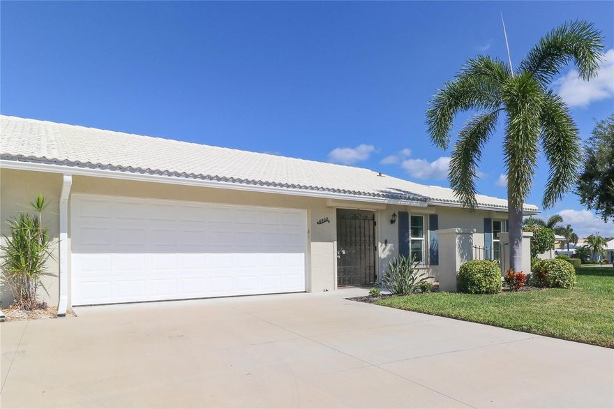 Enjoy the ultimate Florida lifestyle in this popular 55+ Village Green paired villa, ideally situated on a quiet cul-de-sac in West Bradenton—just 5.7 miles from the beautiful beaches of Anna Maria Island. This welcoming community is not in a flood zone, offering peace of mind along with a relaxed coastal vibe.
Step inside and discover 1,913 square feet of air-conditioned living space with an inviting glass-enclosed Florida room overlooking a tranquil greenbelt. The open, spacious floor plan features two oversized bedrooms with generous storage, a bright living and dining area, an eat-in kitchen, and a two-car garage. A charming wrought iron gate secures the front entry, adding both privacy and appeal.
Recent updates enhance the home’s comfort and style, including a new tile roof, updated windows, granite kitchen countertops, a stainless-steel double sink, and pull-out cabinet drawers. The kitchen also offers a large pantry with pull-out shelving. Both bathrooms have been tastefully renovated, and the home features fresh interior paint and new laminate flooring throughout—no carpet. Laundry is conveniently located just off the kitchen, and the unit comes equipped with a water system.
This land-owned property includes a $350 monthly condo fee (paid quarterly), covering basic cable TV, internet, exterior painting, annual roof cleaning, common area taxes, community amenities, escrow reserves, grounds maintenance, landscaping, exterior pest control, and pool upkeep. Centrally located, the villa offers quick access to shopping centers, medical facilities, a wide array of restaurants, G.T. Bray Park, Robinson Preserve, the Downtown Riverwalk, and the Gulf beaches. Nearby airports include Sarasota Bradenton, Tampa, and St. Pete. For your private showing, contact the listing agent today.