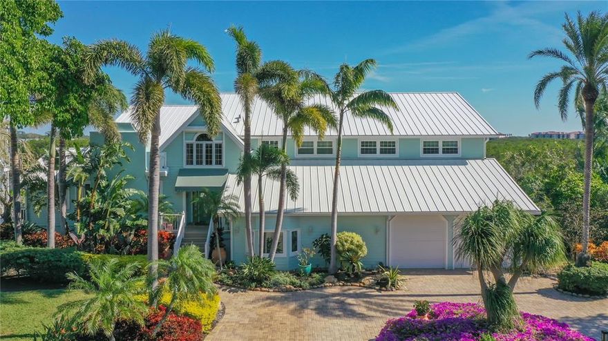 A premiere waterfront location in sought-after Siesta Cove with open views and no bridges to the Bay! MAJOR renovations have been completed to this magnificent coastal-style home located on protected deep water with private, open views of the Intracoastal waterway, beautiful, lush landscaping, 5 spacious bedrooms, and a delightful, welcoming feel from the moment you enter the 2-story light-filled foyer that continues throughout.  Gleaming wood floors flow through the main living areas including the living room with wood-burning fireplace, the generous family room with separate full built-in bar and the generous size formal dining room with chair rail &French doors leading out to a screened deck. Included on the first level is a bedroom with a full bath currently set up as a den, a half bath, and a large hobby room w/built-in desk & custom shelving that leads to the outdoor screened area with hot tub and full pool bath. The kitchen highlights tons of cabinet space, walk-in pantry, center island, breakfast bar plus dual built-in ovens and opens to the breakfast room, a perfect place to start the day bathed in abundant natural light from a bay window overlooking the water. The second story is equally exceptional, with two large guest bedrooms with water views, (one with 2 walk-in closets) that share a center full bath with dual vanities, an activity room or possible upper den, large laundry room with lingerie sink & beverage fridge, a third guest bedroom with en-suite bath and fitted 6x9 walk-in closet. The main bedroom suite (18x35) is a perfect retreat to relax by the fireplace or gaze at the tranquil views of the open bayou out to the Intracoastal and features a glam room-size custom fitted closet with window seat & center storage island. Ground floor A/C finished exercise/game room leads to the newly surfaced two-car garage w/electric car charging station. Outside living is unparalleled, with multiple open and screened decks, and terraces leading to the open 30x18 pool & spa, the 120’ Trex dock with electricity, water and a 10,000 lb. boat lift. Additional outstanding features include an aluminum roof (2017), hurricane impact windows & doors, central vacuum system. This convenient location puts you just a stone’s throw from world-famous Siesta Key Beach and all the shopping, dining & cultural amenities of downtown Sarasota. Room Feature: Linen Closet In Bath (Primary Bedroom).