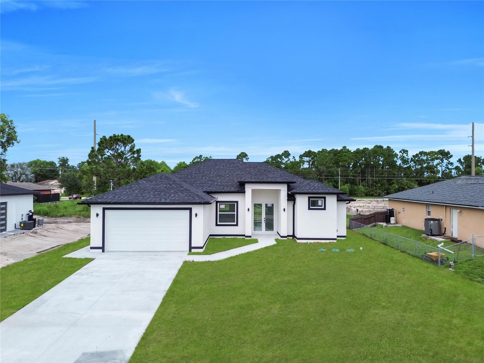 Beautifully crafted new construction offering the perfect blend of style, function, and location. This 3-bedroom plus den, 3-bathroom home features sleek all-white tile flooring and an open-concept layout ideal for both daily living and entertaining. The kitchen showcases a massive island with sparkling white granite countertops and white shaker cabinets, offering a bright, modern aesthetic. The third bedroom includes a private en-suite bathroom—perfect for guests or extended family. Step outside to a fully tiled lanai, thoughtfully designed with space to build your dream outdoor kitchen. Located just minutes from SR 82, this home offers easy access to Fort Myers, Naples, shopping, and dining. Seller is offering $10,000 toward buyer's closing costs and prepaids, making this an incredible opportunity to move into a brand-new home with added savings. Don’t miss out on this must-see property in one of Lehigh Acres’ most convenient and fast-growing areas.