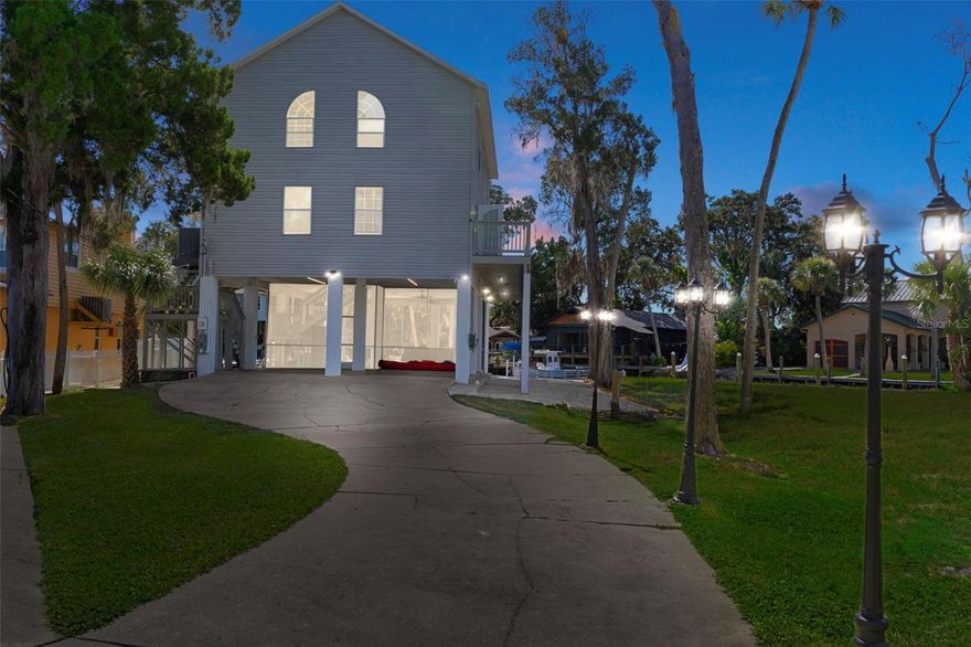 If you’ve been dreaming of a place where every day feels like paradise, welcome to 5272 Tropical Point. Tucked near the quiet end of the beautiful, spring-fed Weeki Wachee River, this elevated home sits high and dry—remaining completely untouched during the 2024 floods and offering peace of mind year-round. With three bedrooms, two baths, about 1,900 square feet of living area and 3,200 square feet under roof, it perfectly combines comfort, practicality, and that laid-back Florida lifestyle everyone loves. Used as a short-term rental for the first time this past summer, it quickly proved to be a profitable retreat, offering flexibility for personal enjoyment or continued rental success.

The lower level is designed for entertainment and convenience. The huge screened lanai, completed in 2024 with a durable acrylic floor, serves as a spacious entertainment area and currently features a pool table—perfect for gatherings, games, or simply enjoying the breeze off the river in a bug-free setting. You can also enter the lanai directly from the carport, keeping you dry when unloading on rainy days. From inside the lanai, an interior staircase leads straight to the main living area, providing easy, weather-protected access to the upper levels.

From the exterior, a poly-wood staircase leads up to the main level’s wraparound deck, where you can take in stunning river, marsh, and sunset views. Step inside to a bright and open living area with 36-foot tongue-and-groove pine ceilings and a wall of windows that span both upper levels, flooding the home with natural light and capturing breathtaking river views from nearly every angle. The fireplace adds a cozy touch, while the kitchen—with granite countertops and a gas stove—is ideal for cooking and entertaining. The primary bedroom on this level opens directly onto the deck through double doors, creating the perfect spot for morning coffee or evening relaxation. The adjoining bath features a flexible layout with a separate shower and sink area, making it convenient for both owners and guests.

Upstairs, two generous bedrooms and a full bath provide a comfortable retreat for family or visitors. The upstairs landing overlooks the two-story open living area below, giving the home an airy, connected feel while highlighting the dramatic pine ceilings and expansive river views framed by those stunning windows.

Outdoors, this property is built for true Florida living. The full seawall runs the length of the lot and leads to a large dock with a ladder for easy water access—perfect for swimming, kayaking, or boating. The dock can accommodate multiple boats, and the storage shed provides extra space for gear and equipment. A fire pit and updated pavers create the perfect setting for gathering under the stars after a day on the water.

With a newer roof (2021), HVAC (2018), fresh interior paint, updated pavers, fans, and other thoughtful touches, this home blends modern updates with effortless riverfront charm. Everything conveys except the ice machine, including furniture, décor, kayaks, fire pit, and outdoor furniture, making this property completely move-in ready.

Whether you’re looking for a full-time waterfront home, a weekend escape, or a property with income potential, 5272 Tropical Point offers it all