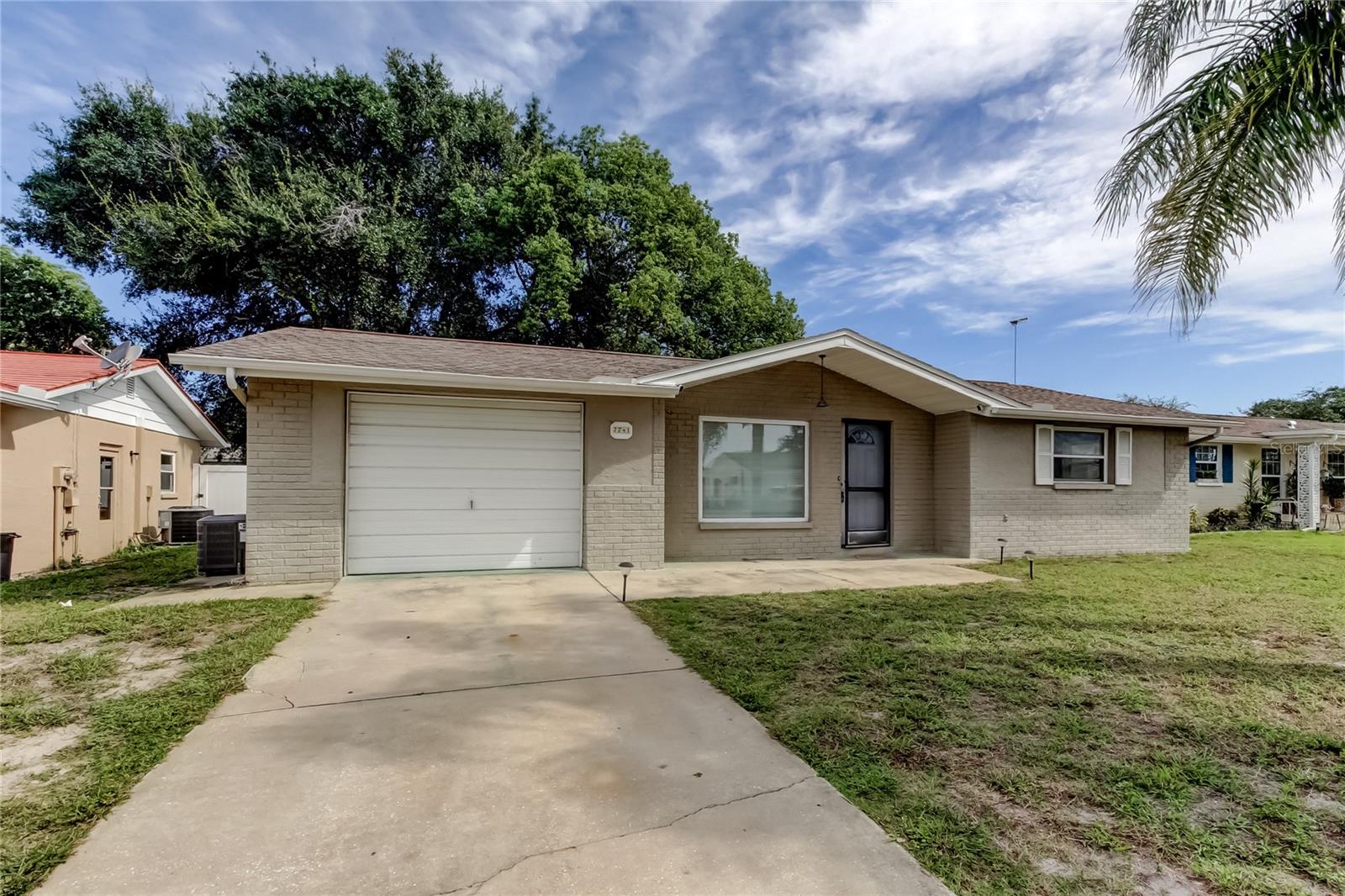 Light, bright, and ready for its new owner! This charming 2-bedroom, 1.5-bath home offers easy living in an established neighborhood and sits in an X flood zone and non-evacuation zone for peace of mind. Inside, you’ll find laminate flooring throughout and vinyl windows for a clean, modern feel. The large Florida room adds flexible living space—perfect as a sunroom, family room, or even a potential third bedroom or office. Important updates include a new roof in 2017 and A/C replaced in 2019, adding comfort and value. The oversized 1-car garage is a true bonus, featuring a convenient half bath with shower and toilet plus washer/dryer hookups. Step outside to enjoy the screened patio, ideal for relaxing or entertaining year-round. Don’t miss this well-maintained home with plenty of potential, all in a desirable location with a great balance of suburban living with easy access to shopping, restaurants and our beautiful Florida beaches.