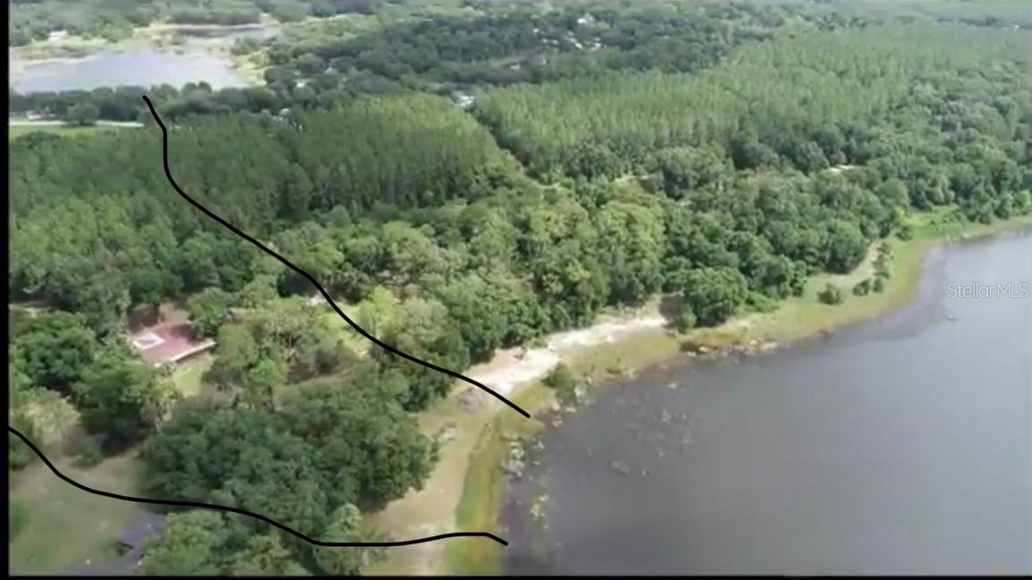 Bring YOUR BOAT & YOUR HORSES!! This 5.32 ACRES of LAKEFRONT property, with its majestic PINE TREES and PRIVATE DRIVEWAY, OVERLOOKS the gorgeous LAKE BESSIOLA in TRANQUIL Ocklawaha!! EVERYTHING is READY for YOU – BRAND NEW 160’ WELL (2023), BRAND NEW ELECTRICAL SERVICE (2024), TWO septic tanks, and a second well – all you need to do is build your dream home when “YOU” are ready! There is NO REQUIRED TIMEFRAME to build and YOU choose your builder! Clearlake Ranches is a small community of only 13 properties (plat attached). ALL BUILDING PADS in Clearlake Ranches are NOT in a FLOOD ZONE! Small HOA in place ~ ONLY $210 a YEAR! ~ For those who LOVE the GREAT OUTDOORS and dream of getting away from all the hustle & bustle – this property is for you! Ocklawaha not only offers privacy – it also offers all kinds of recreational activities like boating (motor boats, pontoons, kayaks, canoes) and fishing (sport or for your own relaxation)! You’re minutes away from the Ocklawaha River, Lake Weir, Silver Springs, Rainbow River, Juniper Springs, and so many more waterways! Ocala National Forest – minutes away – great for walking, hiking, biking, and enjoy the ATV trails! Easy drive to Ocala or The Villages. ~~ There is an old home on the property that was built in 1966. Although its slab and support pilings are still in place, it is not mortgageable. The home is in very bad condition and probably a teardown which is why this property is being sold as “LAND”. ~~ THIS PROPERTY is a MUST SEE! SURROUND YOURSELF with NATURE!!! YOU DESERVE IT!!