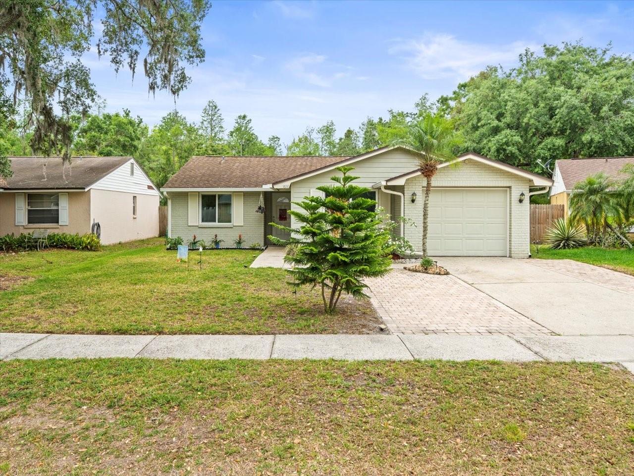 Want serene views from your home? This lovely updated 3Br/2Ba home is located on a nice lot with a rear view of the Brushy Creek system and conservation. Lot extends into the conservation area. It has a fenced yard and paver driveway with extension for extra parking. This home has been beautifully upgraded with luxury vinyl floors through out, updated bathrooms, kitchen remodeled in 2021 features white shaker cabinets, granite countertops and Stainless Steel appliances. Roomy laundry room with extra room for storage/pantry. Great Room plan with split bedroom layout. Primary bedroom has remodeled en suite bath . Custom Vinyl impact windows and slider(2021). Spacious screened lanai, outdoor firepit, and conservation views. One car enclosed garage. Water Heater replaced 2020, new soffits 2019, and roof 2017. This home is located in Northdale on a quite street within The Woodlands. It is conveniently located with easy access to Veterans Express Way, I-275 and downtown Tampa, and the beaches. Minutes to nearby grocery stores, restaurants and retail shopping. Neighborhood amenities include YMCA, Northdale Community Center, Northdale /Lake Park Trail system and a highly sought after school district. Washer and dryer do not convey.