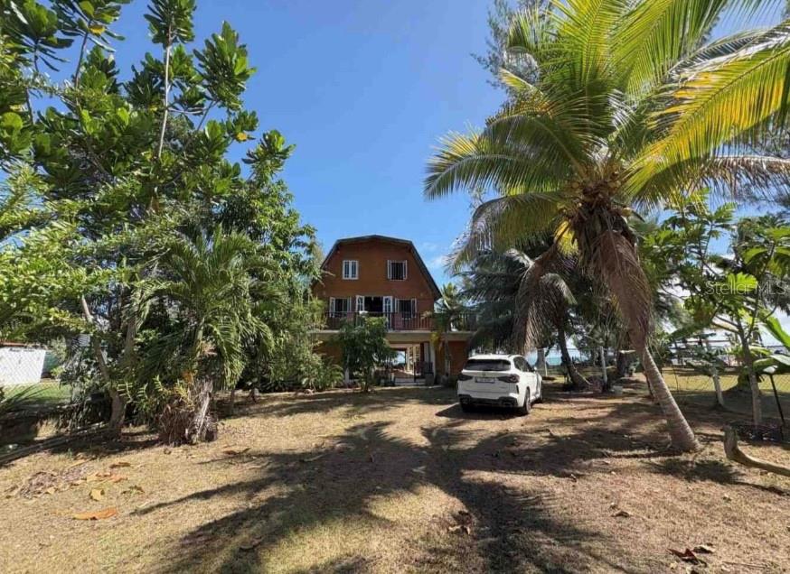 Romantic 3-Story Beachfront Cottage — Private Retreat & Investment Opportunity in Rio Grande
Discover the perfect blend of charm, comfort, and opportunity with this 3-story concrete beach cottage — combining solid construction with the warmth of wood ceilings and the beauty of the sea. Whether you’re seeking a private retreat, a family-friendly coastal home, or an exceptional vacation rental investment, this property offers it all.
Set on 1,101 m² (approx. 0.27 acres) of deeded, fenced, and landscaped land, this property features approx. 2,974 sq. ft. of living space thoughtfully designed for indoor-outdoor living. Both the land is deeded, the home has electric and water access, and the property is registered with CRIM for property taxes — ensuring clear title and ease of ownership.
Inside, you’ll find three bedrooms, three bathrooms, and a fully equipped kitchen on the main floor. The wood ceilings add character and warmth, while large windows and glass doors bring in natural light.
The second and third floors feature wraparound balconies, offering breathtaking views of the beach and ocean. A spacious terrace with a BBQ area and a second kitchen creates the perfect setting for entertaining or relaxing with family and friends.
Ideally located on Puerto Rico’s scenic eastern coast, this property is near top-rated resorts, the El Yunque Rainforest, and just 45 minutes from San Juan and the Caribbean’s largest marina. This home offers a rare combination of privacy, luxury, and convenience — plus outstanding potential as a sought-after vacation rental.Whether for personal enjoyment or as a smart addition to your real estate portfolio, this romantic beach cottage invites you to experience the best of island living.