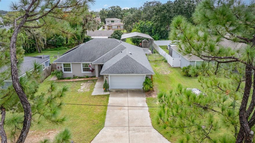 Winter Haven's HOT, and so is this new listing!  Built in 2019, this single family residence is located between Lake Martha and Lake Elbert steps away from Polk State College.  There's no HOA or CDD, but there IS a Carolina Carport with space for your RV, boat, ATV, trailer, etc.  This parking pad is secured with hurricane anchors and has 160 MPH wind rating!  Venture inside, and you will find a spacious split floor plan with open kitchen, complete with stainless appliances, stone countertops, lighted closet pantry. Extra refrigerator means extra cold storage! There's luxury vinyl floors throughout the home, a spacious laundry room, primary en suite with lovely modern soaking tub, dual sinks, private water closet, and walk in shower with so many extra details! Venture outside, and enjoy the patio that extends the entire width of the home, with covered areas complete with fans to improve our outdoor enjoyment! The yard is spacious, with space for raised bed gardening or simple enjoyment of the outdoors.  HARD TO FIND extras like the WASHER & DRYER, 5T HVAC unit with UV has transferrable warranty, SECURITY SYSTEM, ADDITIONAL Insulation in attic, & SOLAR.  You won't find a better deal, so call me while she's available!