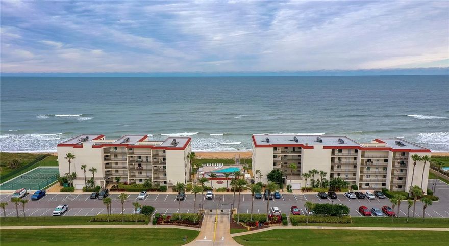 Rare Opportunity in New Smyrna Beach! Direct Oceanfront Corner Unit!  Wake up to breathtaking panoramic ocean views in this beautifully updated, fully furnished end unit in the gated Chadham by the Sea. Positioned directly on the no-drive beach, just a stone's throw to Appollo Beach and Canaveral National State park, This spacious 3-bedroom, 2-bathroom unit offers a spacious open layout with tile flooring throughout, brand new windows and sliders, and a seamless blend of indoor comfort and beachfront luxury.  The kitchen impresses with granite countertops, stainless steel appliances, and a breakfast bar that opens to oceanfront dining and living areas. The primary suite is a serene retreat with coastal-inspired tones, walk-in closet, and a spa-like ensuite featuring a large walk-in shower with frosted glass doors, a granite-topped double sink vanity, and warm wood cabinetry.  Two additional bedrooms offer flexible space for guests, home office, or personal retreat, while the in-unit laundry closet provides added convenience.  Step out to the balcony to enjoy morning coffee or evening sunsets, capturing uninterrupted views of the Atlantic. Chadham by the Sea is a gated, oceanfront community offering resort-style amenities including a beachfront pool, clubhouse, tennis and shuffleboard courts, barbecue area, and a private beach boardwalk to the sand all set in a meticulously maintained setting. STR friendly with a 30 day min. Indulge in the epitome of coastal living, where every moment is a celebration of the sea and the endless horizon. All information recorded in the MLS is intended to be accurate but cannot be guaranteed.