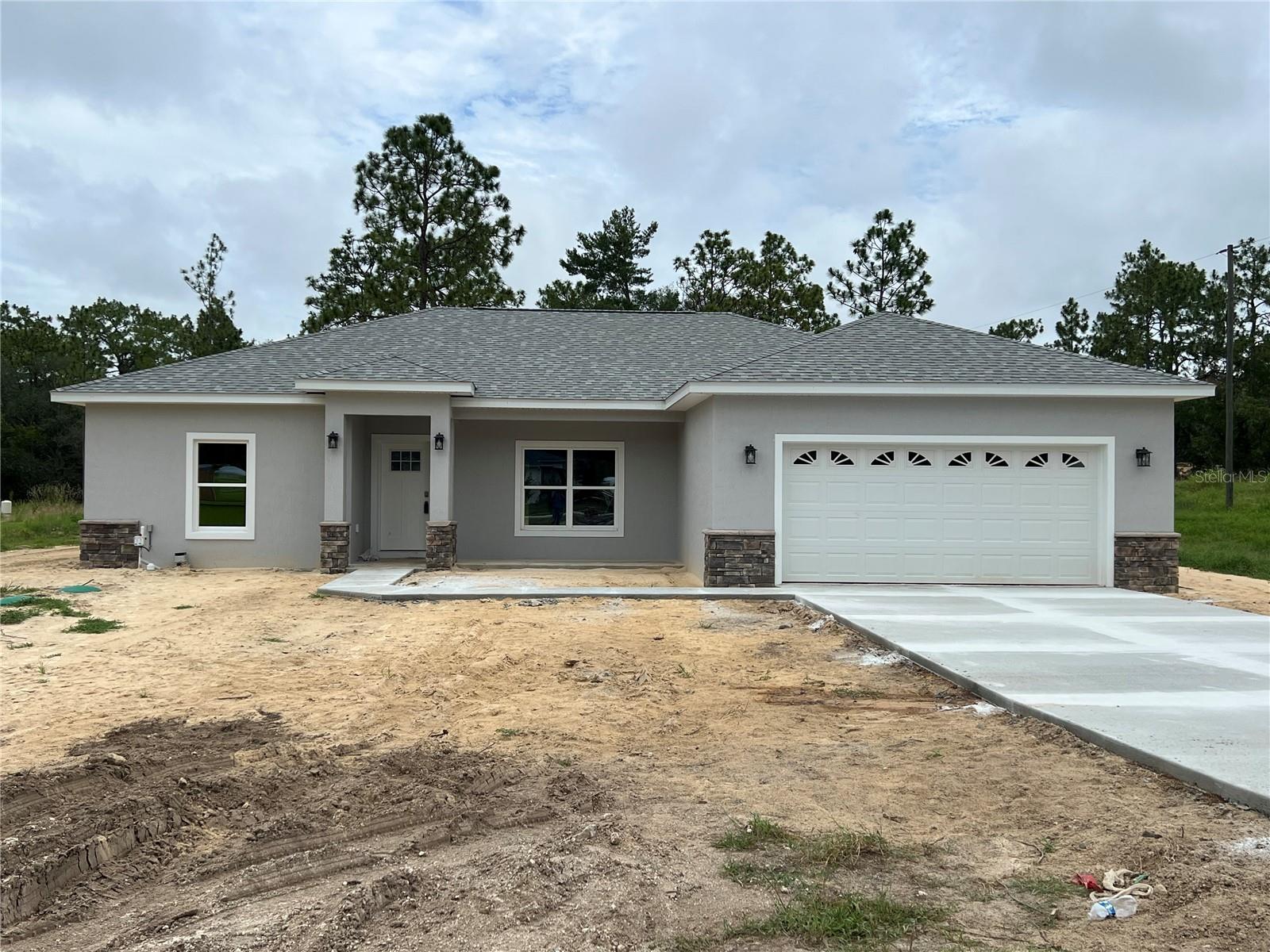 Under Construction. Brand new 3/2 on .99 acre corner lot in Rolling Hills. Home is almost complete. Features, luxury vinyl plank flooring throughout except bathrooms which are tile. Split bedroom plan, open floor plan in kitchen, dining, living area with high ceilings. Large pantry, stainless steel appliances, granite countertops, kitchen with eat at bar. Master bedroom with walk in closet and tray ceiling. Master bathroom has double vanities, walk in shower and linen closet. Inside laundry room. Front and rear covered porches.