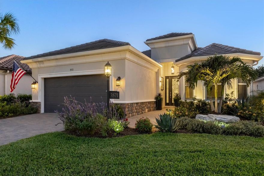 Experience resort-style living every day in this beautifully appointed Lazio model in Esplanade at Azario — where luxury, wellness, and recreation come together in one exceptional community. One of Taylor Morrison’s most sought-after floor plans, this residence offers 2,380 square feet of thoughtfully designed living space with 3 bedrooms, 3 full baths, a private study, and a spacious three-car tandem garage. From the moment you enter through the grand foyer with soaring ceilings, you’ll appreciate the home’s elegant finishes and open-concept design. Neutral tile flooring, bright interior paint, crown moldings, tray ceilings, 8’ doors, upgraded lighting fixtures, custom wainscoting, designer wallpaper, and stylish window treatments create a sophisticated yet inviting atmosphere throughout. The cozy great room with Dimplex linear electric fireplace flows seamlessly into the designer kitchen. The kitchen features stylish two-tone cabinetry, quartz countertops, large center island with prep sink and additional storage, stainless steel GE Cafe appliances, and a generous pantry, making it ideal for entertaining and everyday living. Sliding glass doors open to the extended lanai, creating the perfect indoor-outdoor lifestyle Florida is known for. The extended lanai’s outdoor living space is truly exceptional, complete with leathered marble pavers, in-cage lighting, Storm Smart hurricane shades, and pre-plumbing for an outdoor kitchen. Relax in the custom heated pool featuring a sun-shelf, three tranquil water features, and an autofill system while enjoying the beautifully landscaped surroundings with additional landscape lighting. The private primary suite overlooks the pool and offers a luxurious retreat with dual sinks, a large walk-in shower with dual shower-heads, a water closet, recessed mirrored medicine cabinets, and a spacious walk-in closet. Two additional guest bedrooms, each with access to their own designated bathrooms, are thoughtfully positioned on the opposite side of the home for added privacy. The tandem 3-car garage offers additional ceiling storage racks and room for your golf cart. Additional upgrades include a whole-house Generac generator, water softener, full-house surge protector, alarm system, automated doorbell and garage systems, built-in speakers in the main living area and lanai, upgraded 10-foot ceilings throughout, and custom landscaping surrounding the home. Living in Esplanade at Azario means enjoying an unmatched lifestyle with resort-style amenities, concierge services, wellness programs, and a vibrant social atmosphere. Residents enjoy their choice of 5 restaurants, a spectacular resort pool with the Bahama Bar, a luxurious wellness center offering massage therapy, skincare, manicures, pedicures, fitness programs, and aquatic classes, as well as an 18-hole championship golf course with public tee times and pro shop. The newly opened 15,000-square-foot Culinary Center provides world-class dining and culinary experiences, all within one of the area’s most desirable communities and conveniently located near highly rated Manatee County School District schools.