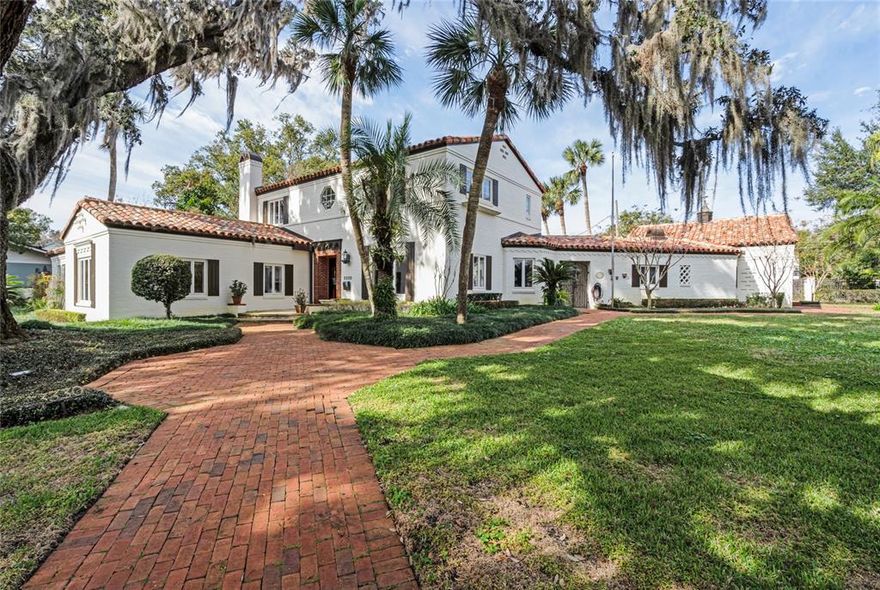 Magnificent Mizner Mediterranean lakefront in the highly sought-after Beverly Shores neighborhood. They don’t build them like this anymore with vintage 1930s architectural details with the utmost quality construction and attention to detail. This home has been impeccably maintained and lovingly updated throughout the years. Enjoy the lakefront lifestyle with expansive views across Lake Sue and relax on the boat dock with covered sitting area and boat lift. The home offers 5 bedrooms and 5 full baths with the primary owner’s suite and separate guest bedroom suite located on the first floor. Upstairs you will find 3 additional bedroom suites including an oversized one that was the original primary suite. There is also a wonderful detached office/pool house off the 3-car garage that can be converted and utilized in various flexible uses, such as a detached guest suite, home office, exercise/media room, etc. as desired. Interior features include true craftsmanship and original exposed beam ceilings, gorgeous wood and tile flooring throughout, detailed moldings/millwork, spacious rooms with high ceilings and plaster walls. The updated island kitchen is equipped with granite countertops, chef’s appliances, dual sinks, custom cabinets and views of the lake. Out back is a resort-like pool area surrounded by an 8’ concrete privacy wall with multiple entertaining areas including covered porch, open patio and summer kitchen. Lake Sue is a private ski lake connected to Lake Rowena via a canal with no public access. Beverly Shores is perfectly located walking distance to Florida Hospital and just a few minutes drive from downtown Winter Park’s famed Park Avenue shopping district or the downtown Orlando business district. Easy to access anywhere without having to get on I-4. Audubon K-8 and Winter Park High School district.