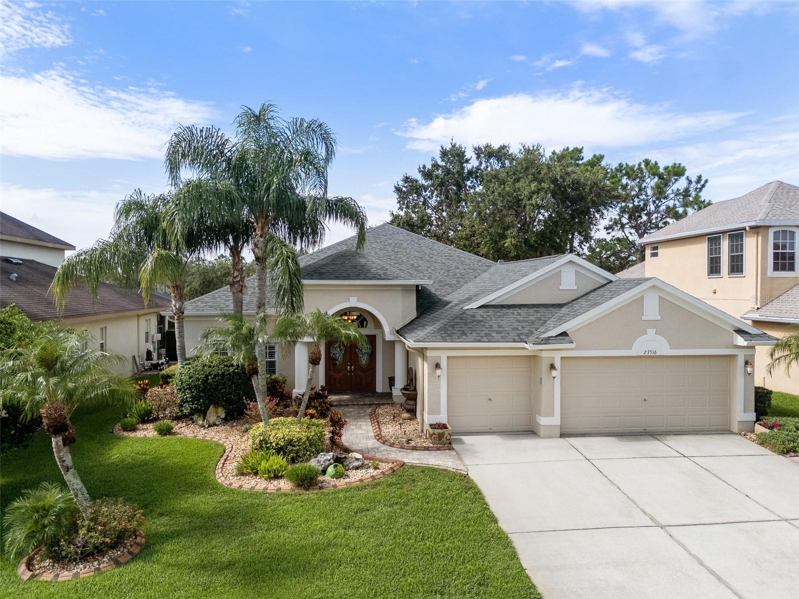 Welcome to this stunning and immaculately maintained 4-bedroom, 3-bathroom home, complete with a spacious study/den, air-conditioned 3-car garage, and an expansive pool and lanai—all beautifully set on the 9th hole of the golf course in the sought-after gated community of Plantation Palms.
From the moment you arrive, the meticulously landscaped exterior sets the tone for the elegance inside. Step through beveled glass double doors into a bright, open layout. To your left, a private study/den offers the perfect workspace, while to your right, the formal dining room is ready to host your most memorable holiday gatherings.
At the heart of the home lies one of the most exquisitely designed kitchens in Plantation Palms—created to impress and perform. Custom knotty Alderwood cabinets lend timeless character with their rich natural grain and warm tones, far surpassing the look of oak, maple, or cherry you see in other homes. These high-end cabinets feature soft-close doors, built-in pullouts, a spice rack, and are anchored by a massive granite island with seating for six. The kitchen is equipped with top-of-the-line stainless steel appliances, a flat-top stove, double convection ovens, and a sleek exhaust hood. Pendant lighting and a reverse osmosis system add to the kitchen’s upscale functionality.
Within the open living space, a custom-built beverage station adds luxury and utility. Glass-front upper cabinets with integrated lighting offer elegant display options, while natural stone countertops, a built-in wine rack, custom drawers, and a wine fridge create the ultimate entertainer’s dream.
The primary suite is a serene retreat, with sliding glass doors that open onto the lanai and frame stunning views of the lush golf course and sparkling pool. The en-suite bathroom features dual vanities, a large garden tub, and a separate walk-in shower.
Step outside to a true outdoor oasis. The extended lanai and oversized pool area offer multiple seating zones to soak up the Florida sun and take in sweeping golf course views. A solar heating system ensures the pool is comfortable year-round.
This home blends high-end finishes, functional design, and the luxury of golf course living. Major upgrades include:
New Roof (2022)
Variable-Speed 4-Ton A/C (2022)
Exterior Paint (2022)
Leaf Filter Gutter System (2022)
Water Heater (2022)
High-End Laminate Flooring (2025)
Interior Paint & 5¼" Baseboards (2024)
Norman Plantation Shutters (2025)
Elongated Toilets
The air-conditioned 3-car garage adds 657 square feet of versatile space—ideal for a home gym, car collection, workshop, or climate-controlled storage.
Plantation Palms offers tree-lined sidewalks, golf and social membership options, and a vibrant clubhouse where you can grab lunch or dinner at Mulligan’s. Enjoy the newly renovated miniature golf course—fun for all ages.
In the heart of Land O’ Lakes, you’re just minutes from Publix, Panera, Starbucks, Walgreens, Wiregrass Mall, major interstates, and medical facilities. Only 35 minutes to Tampa International Airport and Downtown Tampa, this location is ideal for travel and convenience.
You won’t find another single-story, 4-bedroom, 3-bathroom, 3-car garage pool home on a golf course—with this level of luxury and upgrades—under $800,000 within an hour of Tampa International Airport.