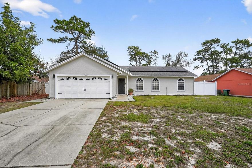 WELCOME HOME!   This lovely 3 bedroom 2 bath POOL home in Deltona Lakes features OPEN FLOOR PLAN and flexible layout no matter if you prefer indoor or outdoor living - this home has you covered!  NO FLOOD ZONE and NO HOA.  This home is LIGHT and BRIGHT with a SPLIT floor plan allowing privacy for everyone.  Open kitchen concept with separate dining area making it ideal not just for cooking, but for conversing with friends and family at the same time.  UPDATED KITCHEN 2023 including: QUARTZ countertops, DEEP single basin stainless steel kitchen sink, UPDATED cabinets, and NEW backsplash, NEWER appliances (2023).  REFRIGERATOR DOES NOT CONVEY.   The second refrigerator (on site) will convey with the home.  Kitchen boasts plenty of counter space for cooking and plenty of storage as well.  Solar panels for lower electric bills installed 10/23.  Other great attributes of the home not to be missed include: NEW SLIDER 2023, home was RE-PIPED (4/23), UPDATED bathrooms (2023), OVERSIZED Primary Bedroom (15x13),  INDOOR LAUNDRY and SCREENED in LANAI leading to the expansive backyard with an IN GROUND POOL.  Plenty of space for a fire pit or adding a playground.  Backyard is 3/4 FENCED for privacy. Taxes will be REDUCED when the home is HOMESTEADED.  Conveniently located near schools, shopping, hospitals, I-4, and minutes from beaches, area attractions, airports, biking and nature trails.  Don't delay...Call your agent and BOOK A SHOWING TODAY!