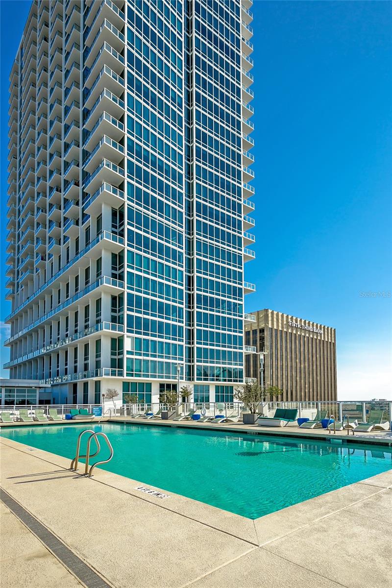 Lake-Facing Two-Level Loft at The Vue • 1 Bed / 1.5 Bath! Renovated and impeccably designed, this two-level condo delivers luxury living with beautiful city and lake views from a premier downtown address adjacent to Lake Eola. Engineered wood flooring runs on both levels, complemented by a designer gray palette and custom light fixtures throughout. A dramatic 20-foot ceiling in the Great Room and walls of glass bathe the space in light while framing sweeping views of The City Beautiful and Lake Eola. Key features include: Two-level layout: 1 bedroom, 1.5 baths, gourmet kitchen with natural gas range and granite countertops, oversized loft primary suite with a massive walk-in closet, spa-like bath with garden tub, power window shades, interior laundry center with storage or bonus room, large balcony, acoustically engineered for superior sound privacy, and a one-car premium parking space within the attached garage. Residence highlights include: engineered wood flooring on both levels, designer gray paint, custom light fixtures, an open light-filled layout with panoramic lake and city views. Building & community amenities include: 24-hour doorman and concierge; biometric access, luxurious lobby and secure entry; resident parking garage, adjacent to Lake Eola with lake and city views from a premier downtown address, Jr. Olympic-size pool and a 30,000 sq ft amenity deck with grills and new furnishings, premier fitness center, tennis courts, media room, dog walk, and Club Vue Lounge, and sound-dampened construction to minimize between-home noise. The Vue offers the finest address in the City Beautiful. Schedule a private viewing to experience this lake-facing loft firsthand.