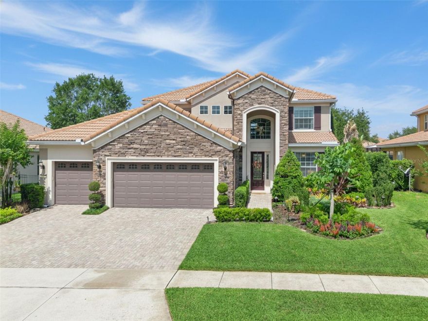 One or more photo(s) has been virtually staged. Beautifully designed for both everyday living and effortless entertaining, this 5BR/3.5BA home is tucked inside the gated Meadow Ridge community adjacent to Thornebrooke Elementary School. Showcasing an upscale Floridian aesthetic, the residence features Mediterranean-inspired architecture, lush mature landscaping, a classic Spanish tile roof, stacked stone exterior accents, and a large attached three-car garage. Bursting with soft natural light, the stunning interior enchants with soaring foyer ceilings, custom moldings, designer light fixtures, recessed audio, an organically flowing layout, elegant formal dining room, and an expansive living room boasting an elegant electric fireplace, and well appointed half bath adjacent the main living space. Thoughtfully planned for easy hosting, the open concept gourmet kitchen features stainless-steel appliances, granite countertops, breakfast nook, double wall ovens, recessed lighting, and a breakfast bar. Sequestered on the main level for privacy, the spacious primary bedroom boasts a custom built-out closet, direct patio access, and a luxurious en-suite bathroom featuring a soaking tub, granite topped dual sink vanity, and a separate shower for a spa-like retreat. Upstairs, four extra bedrooms and two full bathrooms satisfy multigenerational needs, while the upper-level flex space may be utilized for lifestyle-specific needs, such as a playroom, family room, or home theater. Venture into the party-perfect fenced backyard to discover your personal oasis with lush, beautifully curated landscaping, a custom heated swimming pool, spa, covered patio with recessed audio speakers, integrated yard speakers, and plenty of room for lounging. Additional features include a laundry room, community clubhouse, community swimming pool, and playground, all just 0.3-miles to Publix and CVS, 2.75-miles to Winter Garden Village Shopping Center, and only 20 minutes to Downtown Orlando or Disney. Conveniently located near SR-408, SR-429, Orlando International Airport, restaurants, medical facilities, and A-rated schools. Welcome home to your next adventure. Schedule your private showing today! Home Owner is a Florida licensed Real Estate Broker. 
See: 487douglasedwarddrive for cinematic video.