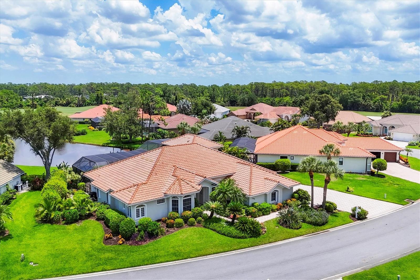 Be immersed in nature at this spectacular, truly unique, custom-built estate home located in Riverwood Golf Club - one of Southwest Florida’s best kept secrets. The home is centered on a one-third acre beautifully landscaped piece of land, perched along a pond with the 4th hole beyond, making for stunning views and breath-taking sunsets. The home is gorgeous both inside and out. The kitchen is a dream, with a fabulous stone waterfall counter top, both an island AND a breakfast bar, step-in pantry, and stainless-steel appliances including a double built-in oven and ice maker. There are 3 bedrooms with ensuite bathrooms in this home; 3 bedrooms and 3.5 bathrooms on the main floor, and a 4th bedroom with full bath, walk-in closet and private patio on the second floor. There’s also an office on the first floor with two built-in desks and plenty of drawer and cabinet space. The living room has a soaring 14 ft high double tray, lit ceiling, and a zero-corner pocketing 14.5 ft sliding glass door that opens an entire wall for an amazing flow to and from the pool area. The back yard space embodies tropical living, with a large, heated pool with a rock waterfall, spa with waterfall and in-pool seating. The panorama screen with tropical foliage both inside and out truly immerse you in nature. The covered lanai area is 38 ft long with plenty of space to socialize and a gorgeous stone outdoor kitchen. The screen lanai is multi-level, to include the 2nd floor balcony with a fun spiral staircase. There are so many amazing features of this home, including: a brand-new tile roof (July 2025!), 2023 lanai screen and picture window, hurricane shutters throughout, pool bath & outdoor shower, intercom & whole home stereo system, 3-car garage with large paver driveway, sprinkler system, breakfast area with aquarium window, zoned Lennox smart AC system. Riverwood is a beautifully landscaped and maintained 1300-acre community, that has won many awards, including as an Audubon Green Community. Amenities include 24-hour supervised gated entry, 6 lighted tennis courts, 6 lighted pickleball courts, a library, fitness center, meeting rooms, craft room, resort pool, lap pool & spa, lawn croquet, bocce ball courts and a dog park. The golf course is consistently rated in the Top 50 Courses in the US and Florida, as well as Top Ten places to play as awarded by Golf Digest. And you are within 15-20 minutes to amazing pristine beaches of the Gulf! Truly a remarkable home in a remarkable community. Schedule to experience it today.