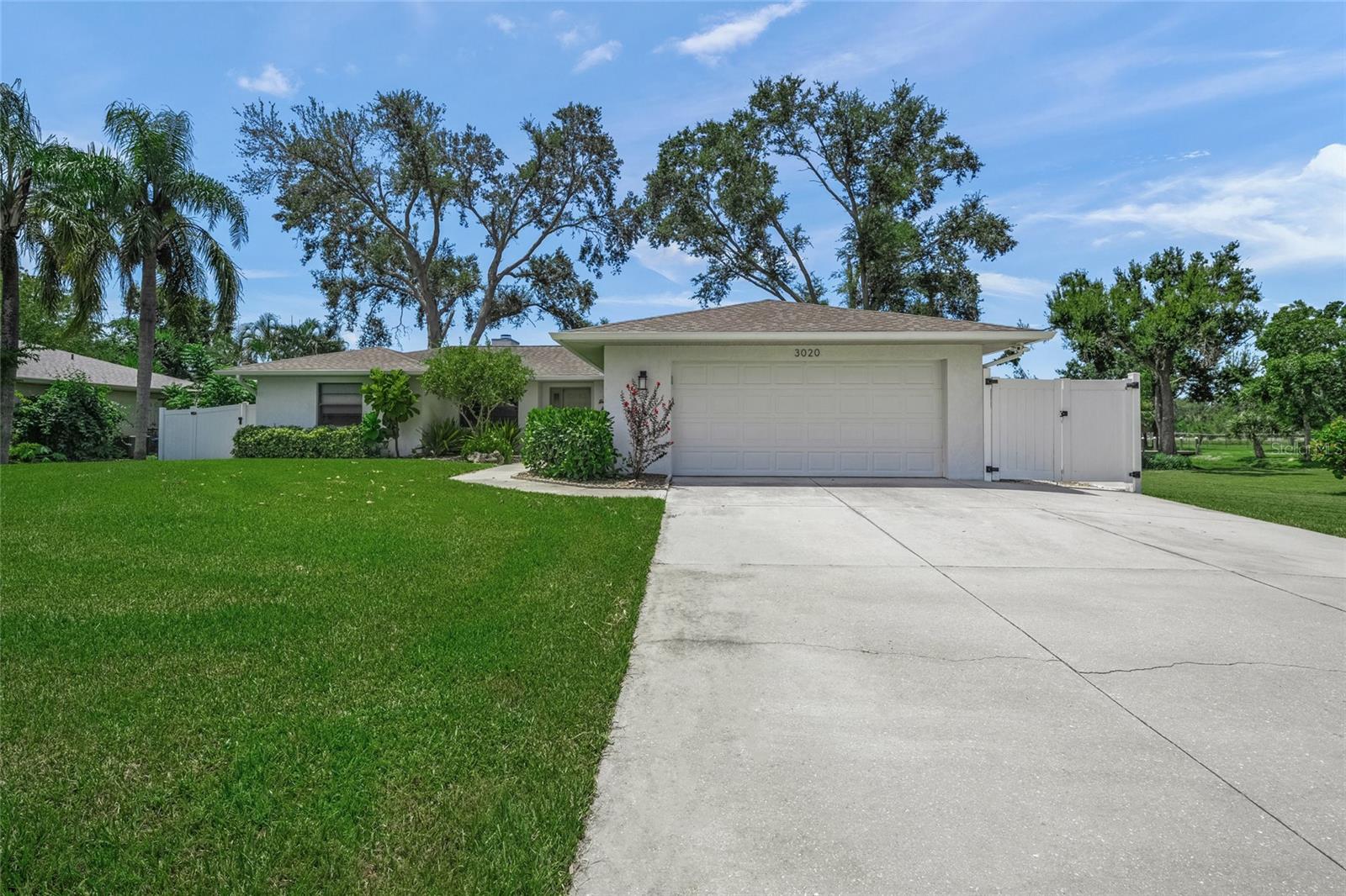 Welcome to 3020 Gypsy Street—where modern design, peaceful privacy, and a prime Sarasota location come together. Originally built in 1993 by an Amish custom builder, this meticulously maintained 3-bedroom, 2-bath residence has been fully redesigned with a fresh, modern aesthetic and thoughtful upgrades throughout.
From the moment you arrive, you'll be greeted by lush, manicured landscaping, a spacious private lot, and undeniable curb appeal. Step inside to find a bright and open split floor plan with luxury vinyl plank flooring, sleek finishes, and abundant natural light. The heart of the home is the updated kitchen featuring crisp white cabinetry, quartz countertops, pendant lighting, stainless steel appliances, a stylish glass tile backsplash, and an oversized island perfect for entertaining.
The spacious living room centers around a striking modern fireplace and flows effortlessly to the dining space and kitchen, creating a true open-concept layout. Retreat to the generously sized primary suite complete with dual sinks, a walk-in shower with designer tile-work, and ample storage. Two additional bedrooms, provide flexibility for families, guests, or a home office.
Out back, relax on the screened-in lanai, or unwind in the fenced yard on the custom stepping stone patio with serene water views—an ideal setting for morning coffee or sunset cocktails. Enjoy the added bonuses of an irrigation system fed by a well, updated roof (2018), and no deed restrictions, offering freedom and flexibility for rental opportunities.
Located just minutes from downtown Sarasota, award-winning beaches like Siesta Key, top-rated schools, local parks, and the area's best shopping and dining—this home is a rare find. Whether you're looking for a primary residence, vacation escape, or a smart investment, 3020 Gypsy Street is ready to welcome you home.