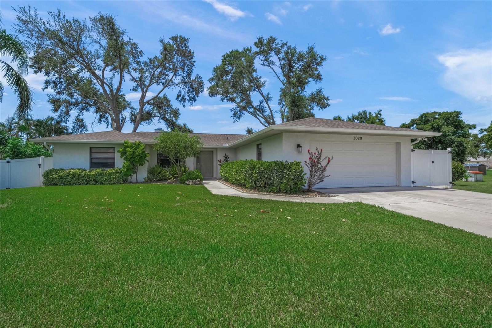 Welcome to 3020 Gypsy Street—where modern design, peaceful privacy, and a prime Sarasota location come together. Originally built in 1993 by an Amish custom builder, this meticulously maintained 3-bedroom, 2-bath residence has been fully redesigned with a fresh, modern aesthetic and thoughtful upgrades throughout.
From the moment you arrive, you'll be greeted by lush, manicured landscaping, a spacious private lot, and undeniable curb appeal. Step inside to find a bright and open split floor plan with luxury vinyl plank flooring, sleek finishes, and abundant natural light. The heart of the home is the updated kitchen featuring crisp white cabinetry, quartz countertops, pendant lighting, stainless steel appliances, a stylish glass tile backsplash, and an oversized island perfect for entertaining.
The spacious living room centers around a striking modern fireplace and flows effortlessly to the dining space and kitchen, creating a true open-concept layout. Retreat to the generously sized primary suite complete with dual sinks, a walk-in shower with designer tile-work, and ample storage. Two additional bedrooms, provide flexibility for families, guests, or a home office.
Out back, relax on the screened-in lanai, or unwind in the fenced yard on the custom stepping stone patio with serene water views—an ideal setting for morning coffee or sunset cocktails. Enjoy the added bonuses of an irrigation system fed by a well, updated roof (2018), and no deed restrictions, offering freedom and flexibility for rental opportunities.
Located just minutes from downtown Sarasota, award-winning beaches like Siesta Key, top-rated schools, local parks, and the area's best shopping and dining—this home is a rare find. Whether you're looking for a primary residence, vacation escape, or a smart investment, 3020 Gypsy Street is ready to welcome you home.