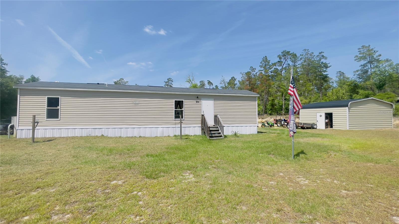 Welcome to Williston Highlands Unit 7! Discover this charming and nearly new 2-bedroom, 2-bath single-wide home nestled on a generous 1.57-acre corner lot along a paved road. This delightful residence, built by Live Oak Homes, offers a cozy yet spacious atmosphere with a thoughtful split bedroom plan. Inside, you'll appreciate the convenient laundry area and an inviting open floor plan that seamlessly connects the kitchen and living spaces. Step outside to find plenty of space designated area for horses, goats, chickens, etc. for animal lovers or those wanting to embrace a bit of country living. The property is fully perimeter fenced for added privacy and security. Additionally, a 24x12 metal storage building with electrical connections provides ample space for your tools and equipment. Don’t miss the opportunity to make this lovely home your own!