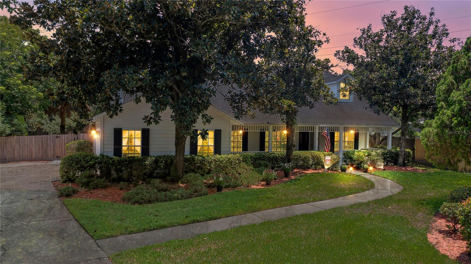 MOVE IN READY Colonial-style home with tons of charm in one of Dr Phillips’ most desirable communities – Turnbury Woods! This home features a large front porch with a swing – right out of a movie (!) with 4 beds, 3 full baths, an office and a large bonus room with a closet that could be used as a 5th bedroom, real wood floors, a screened in pool, patio and trex deck balcony, on almost an acre of land that’s fenced in! You will love the vaulted ceilings, wood trim throughout, wood staircase railing, formal spaces and open floor plan. The formal living and dining rooms will be on your left with the family room in front of you that features vaulted ceilings and a brick enclosed wood burning fireplace. The beautiful kitchen overlooks the pool and features wood cabinets, tile backsplash, crown molding, granite counters, a breakfast bar, a breakfast nook overlooking the pool, stainless steel appliances with a new LG smart, wi-fi enabled, insta-view door-in-door French door fridge and new LG microwave. The laundry room is off the kitchen, comes with both an LG washer and dryer and leads to the oversized side entry two-car garage and also has a door leading to the covered downstairs ceramic tiled patio that overlooks the beautiful tiled pool and large yard. What a great space to enjoy your morning coffee or unwind after a long day! The owner’s suite is downstairs and on the other side of the home and has a new remote controlled ceiling fan and a view of the backyard. The large en-suite bath features vaulted ceilings, two separate granite top vanities, one with space for makeup, a frameless glass enclosed tiled shower, a separate ceramic tiled soaking tub surrounded by a new glass block wall for privacy in addition to a spacious walk in closet. There’s another bedroom and full bath downstairs with a new one-sink vanity, new light fixtures, wallpaper and high efficiency toilet with a soft close lid. Upstairs you will find two additional bedrooms, a small office and an oversized bonus room with a walk-in closet for extra storage. A French door leads to a trex deck balcony in the screen enclosure. A screen door leads to a staircase that takes you to the oversized, fenced yard that has gopher tortoises. This home has been beautifully maintained! Additional updates include a new 16 seer HVAC with digital thermostat downstairs (2025), new drain field (2023), new roof (2018), hurricane grade screen enclosure (2018), new upstairs 16 seer HVAC with digital thermostat (2016), newly painted front porch railings, new landscaping in the “secret garden” – the fenced in area outside the owner’s bathroom, with artificial turf and a bistro set, newer wallpaper in the dining room and the upstairs bathroom has been re-painted. Centrally located in the heart of Dr Phillips, close to the Bay Hill golf course and country club, minutes to restaurant row and great dining, shopping at the Millenia mall or outlets, zoned for great schools and close to the theme parks. Come live in one of the most desirable communities in Dr Phillips in this picturesque home!