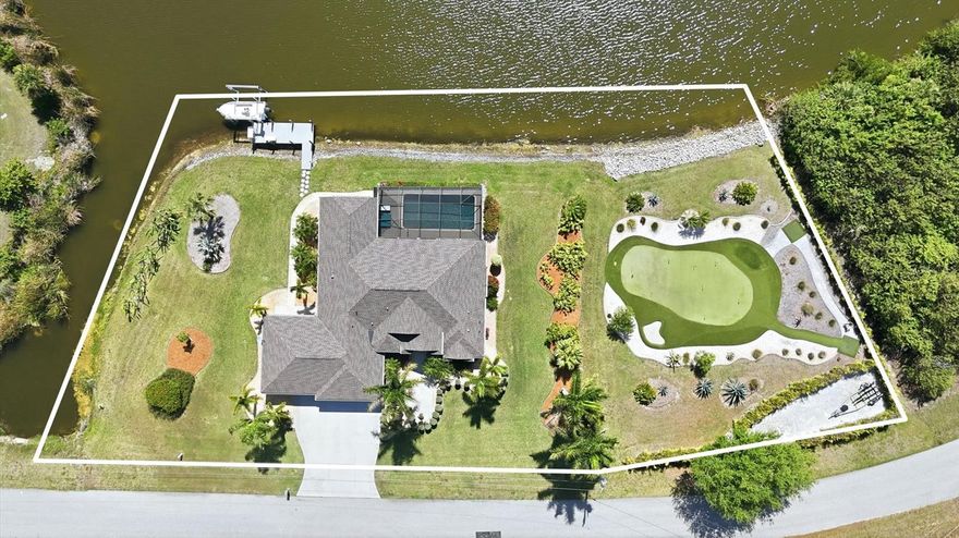 Look no further, your waterfront estate with 260 feet of shoreline and a private putting green awaits. Perfectly positioned on a rare TRIPLE LOT along one of the widest sections of the Santa Cruz Waterway, this exceptional residence delivers an elevated Florida lifestyle defined by space, privacy, and refined outdoor living. Offering 2,109 square feet, this 3-bedroom, 2-bath home is being offered FURNISHED, allowing for an effortless, move-in-ready experience. From the moment you arrive, the expansive grounds and lush, manicured landscaping create a striking first impression. Inside, the home blends comfort and sophistication with a thoughtfully designed layout ideal for both everyday living and entertaining. The completely updated kitchen serves as a stunning focal point, featuring beautiful quartz countertops, new cabinetry, and a clean, modern aesthetic that elevates the entire space. The primary suite is a true retreat, complete with dual closets and sliding glass doors that open seamlessly to the outdoor living area, perfectly capturing the essence of indoor-outdoor coastal living. Step outside and experience what truly sets this property apart. Your private waterfront oasis showcases a heated pool with a newer heater (2021) and a newly re-screened lanai (2023), all overlooking 260 feet of breathtaking waterfront. A private dock and boat lift provide direct access to open water, creating an exceptional setting for boating enthusiasts. The additional lot further enhances this one-of-a-kind property, featuring your very own beautifully maintained putting green, surrounded by lush tropical landscaping, offering a true resort-style experience right at home. Recent updates include a new roof (2023), adding peace of mind and long-term value. Additional features include irrigation for effortless lawn care and an insulated garage with a dedicated workshop space. Located in the highly sought-after waterfront community of South Gulf Cove, offering over 55 miles of navigable canals, this property is ideally situated between Sarasota and Fort Myers and just minutes from world-class fishing, championship golf, pristine Gulf beaches, dining, and shopping. This is more than a home, it is a rare waterfront offering defined by unmatched frontage, curated outdoor living, and a lifestyle designed to impress. Paradise awaits.