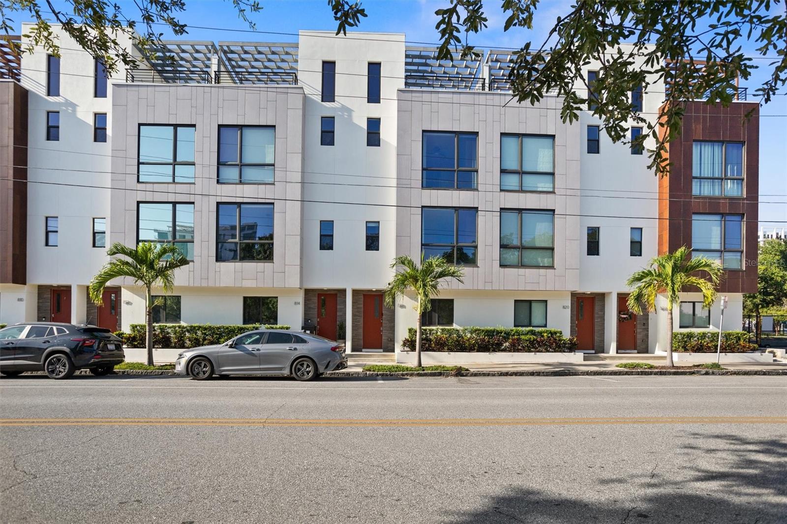 Bold. Modern. Downtown. Welcome to your next-level lifestyle in the heart of Downtown St. Pete — where sleek design, smart living, and rooftop vibes collide in one unforgettable address. Tucked away in a gated community, this stunning four-story townhome is more than a place to live — it’s a statement. From the moment you walk through the door, you’re greeted by modern interiors, setting the tone for the elevated living that awaits. You’re welcomed to a main floor bedroom/office with en suite bathroom perfect to work from home or welcome guests. The heart of the home — draws you in with its sleek cabinets, stainless steel appliances with gas fired cooktop, and microwave. Whether you're hosting dinner parties or sipping your morning coffee, this open-concept space flows effortlessly into the living area, creating the perfect backdrop for entertaining and everyday life. Mohawk wood flooring guides your steps as natural light pours in from floor-to-ceiling windows. The thoughtful layout continues upstairs, where the primary suite offers not one, but two spacious walk-in closets, a double vanity, and a glass walk-in shower — your personal retreat after a long day. The home is equipped with smart technology at every turn, including smart locks, alarm, video doorbell camera — all designed for seamless, secure living. But the crown jewel of this residence? The private rooftop terrace. Imagine unwinding under the pergola, grilling with friends, mixing cocktails at the rooftop wet bar, or catching the game on your TV — all with the city skyline as your backdrop. This space isn’t just an amenity, it’s your urban oasis in the sky. A private two-car garage offers ease and security. On the same level as the primary bedroom there is a dedicated laundry space with top-loading washer and dryer, making daily tasks a breeze. Location, of course, is everything. And with a Walk Score of 93, you’re living in the heart of it all. Just two blocks from Central Avenue’s buzzing restaurants, coffee shops, and boutiques. A short stroll to waterfront parks, The Pier, and world-class museums. And when you're ready for a change of scenery, the white sands of St. Pete Beach and the terminals of Tampa and Clearwater airports are only 15 minutes away. This is more than a townhome — it’s your front-row seat to everything downtown St. Pete has to offer. Owner pays HOA which includes trash, water, cable and Internet. Schedule your private tour today and experience the energy, elegance, and ease of your next home.