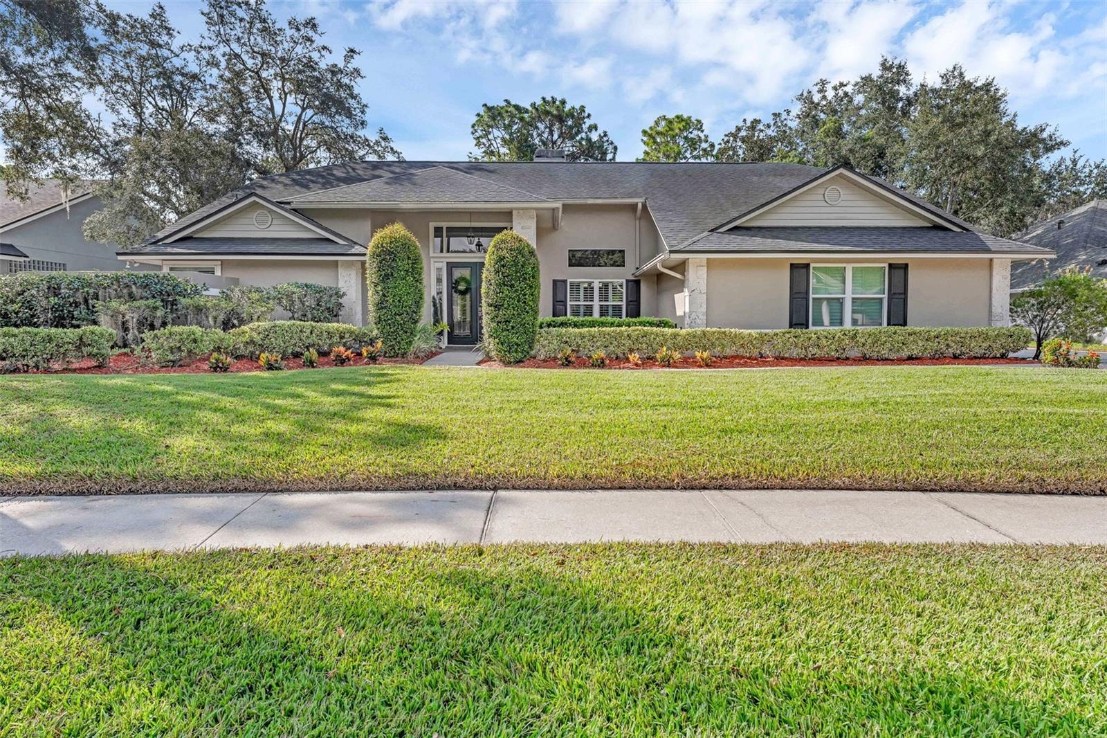 Elevate your lifestyle in this stunning, single-story executive home tucked in the prestigious Glen Eagle community of Winter Springs. Fully remodeled with artisan touches, this 4-bed, 3.5-bath retreat spans 2,800 sq ft on a generous third-acre lot. Main bedroom suite feels like a private spa with a sitting area, frameless shower, garden tub and tile, dual sinks, and an expansive layout. The heart of the home—a true chef’s kitchen with quartzite countertops, top-tier 42” cabinetry, built-in ovens, a farmhouse-style sink, built-in ice maker, wine storage, and a breakfast bar. A cozy breakfast nook adds charm too! The kitchen opens seamlessly to a family room with cathedral ceilings, transom windows, and a dramatic floor-to-ceiling Coquina shell fireplace, flanked by French doors leading outside. Entertain outdoors in style with a covered lanai with a custom summer kitchen is perfect for al fresco dining and entertaining. A sparkling pool with beautiful brick pavers creates a resort-like retreat. Luxurious upgrades abound, from engineered hardwood and porcelain-tile floors (no carpeting), plantation shutters, and remodeled baths throughout. The oversized 2.5-car garage includes a workshop space, while the split floor plan ensures privacy and comfort throughout. Zoned for A-rated schools and moments from shopping, parks, and expressways, this home is not just a sanctuary—it’s a lifestyle!