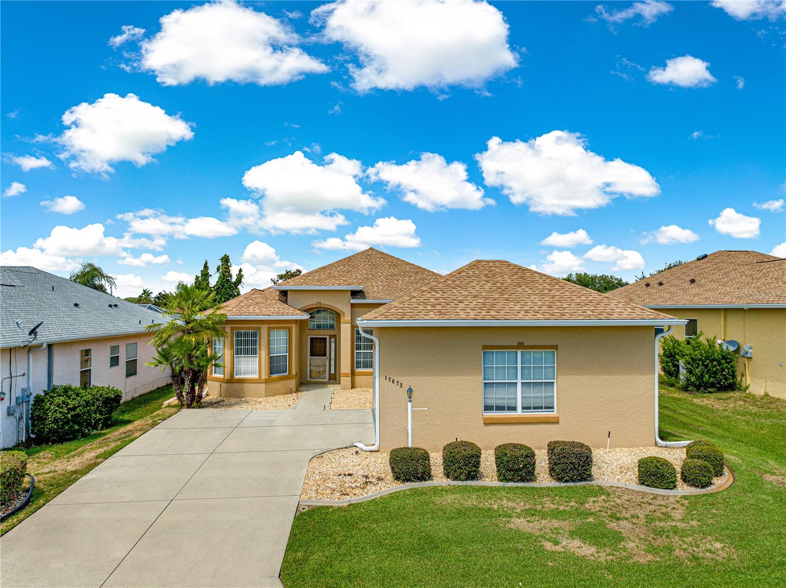 This is the first time this one owner home has ever been on the market! This St George model offers undeniable curb appeal with it's oversized driveway leading into the side facing oversized garage and beautiful entrance with mature landscaping. Over 1900 sq ft of living space with 10' ceilings! This home offers plenty of space to host your guests with a foyer as you walk in and a spacious living room that leads out to a large enclosed lanai to enjoy those gatherings with friends and soak in those beautiful Florida sunsets. The master bedroom offers a large walk-in closet, generous en-suite with soaking tub, double vanities and walk in shower. The second bedroom has a large built in closet and the third bedroom/den is perfect for guests, an office, craft room or work-out room. The kitchen has lots of counter space, cabinets and a storage pantry to store all of the tools needed by those home chefs. Separate inside laundry and an oversized 2-car garage with plenty of room for that golf cart that is INCLUDED with this home. Located in the beautiful, active community of STONECREST just outside of The Villages. Stonecrest offers over 100 Clubs, Pickleball, Softball, a Workout Center, 4 Pools, Security and much more! You will also have golf cart access to Walmart, shopping, restaurants and more. Stonecrest's fabulous location allows easy access to restaurants, shopping, the hospital and medical facilities. Your piece of paradise awaits you!! Don't miss out on this one! New roof in 2020 and a new HVAC was installed in 2016. GOLF CART INCLUDED!