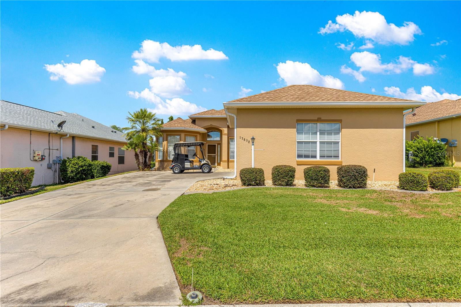 This is the first time this one owner home has ever been on the market! This St George model offers undeniable curb appeal with it's oversized driveway leading into the side facing oversized garage and beautiful entrance with mature landscaping. Over 1900 sq ft of living space with 10' ceilings! This home offers plenty of space to host your guests with a foyer as you walk in and a spacious living room that leads out to a large enclosed lanai to enjoy those gatherings with friends and soak in those beautiful Florida sunsets. The master bedroom offers a large walk-in closet, generous en-suite with soaking tub, double vanities and walk in shower. The second bedroom has a large built in closet and the third bedroom/den is perfect for guests, an office, craft room or work-out room. The kitchen has lots of counter space, cabinets and a storage pantry to store all of the tools needed by those home chefs. Separate inside laundry and an oversized 2-car garage with plenty of room for that golf cart that is INCLUDED with this home. Located in the beautiful, active community of STONECREST just outside of The Villages. Stonecrest offers over 100 Clubs, Pickleball, Softball, a Workout Center, 4 Pools, Security and much more! You will also have golf cart access to Walmart, shopping, restaurants and more. Stonecrest's fabulous location allows easy access to restaurants, shopping, the hospital and medical facilities. Your piece of paradise awaits you!! Don't miss out on this one! New roof in 2020 and a new HVAC was installed in 2016. GOLF CART INCLUDED!