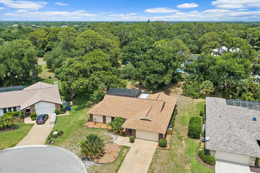This home is situated on a large private cul-de-sac lot in the highly desirable Bet Tree Village 2 Community.  Updates include a recently rescreened mansard pool cage in 2025 and a the large in-ground pool was just remarcited this year.  A new roof was installed in 2025 and both the interior and exterior of the house has just been painted.  The kitchen has also been updated with wood cabinetry, a storage pantry and granite counter tops.  The SS appliances are new. The kitchen also offers a built-in breakfast bar and sliding glass pass-through windows that open onto the lanai/pool area. The open floorplan is family friendly and features a "split bedroom" layout, with walk-n closets in all the bedrooms.  The large common bathroom also opens to the pool area.  The large family room has vaulted ceilings and a built-in entertainment cabinet.  The living room is also spacious and is adjoins the dining area.  All 4 of the sliding glass doors completely recess as to allow a wide open airy access to the big lanai/pool area.  Bent Tree Village 2 offers a fantastic gated community with winding roads, a community park area and larger than average lots...