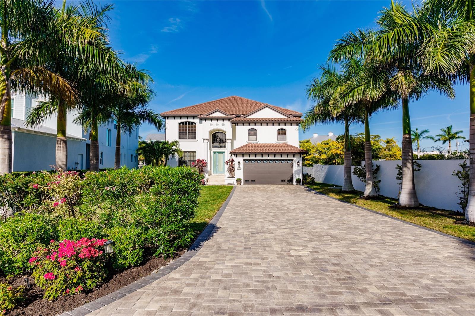 The experience of LUXURY WATERFRONT living begins here at this stunning estate! Boasting 4 bedrooms, 3.5 bathrooms, an oversized 2-car garage with 10-foot ceilings and hanging storage racks, an extra wide NEW PAVER DRIVEWAY, and stunning NEW LANDSCAPING of the entire residence, complete the natural curb appeal of this already gorgeous home. Stepping indoors, the formal living area to the left becomes the perfect place to greet friends and family as they arrive and showcase your beautiful adjoined dining space! Ten-foot ceilings, warm natural lighting, and a massive open floor plan naturally propel you further into this luxurious home. The kitchen boasts a WALK-IN PANTRY that will make the chef of your home giddy with joy - DOUBLE OVENS, stainless steel appliances, a GAS RANGE, granite countertops, and EAT-IN BREAKFAST BAR. The informal dining area right off the kitchen makes 3 separate designated areas for your friends and family to gather and eat! This residence features a 4-stop elevator from the Garage to every level. The Primary Master Suite features tray ceilings and large windows that cover the room with natural lighting, a JETTED SOAKING TUB, double HIS & HER vanities (with makeup vanity included), a private toilet, and a large WALK-IN SHOWER with separate shower heads and modern GLASS DOORS. The primary suite further impresses by granting access (from ensuite) to a private WATERFRONT BALCONY with a designated lounging area that is perfect for relaxing with a good book or unwinding at the end of a long day. A second ensuite features an oversized bedroom with beautiful views and natural lighting. Let's talk more about the incredible outdoor features! Directly off of the kitchen is a large SCREENED-IN and COVERED PATIO perfect for outdoor entertaining. The stylish PAVER DECKING compliments the LARGE POOL and SPA and comes fully fenced-in with aluminum fencing panels to enclose the entire area for privacy and safety. This home is a boater's dream with a new 46' MULTILEVEL DOCK with high-performance TREX DECKING, a 16,000 LB BOAT LIFT, and a matching PAVER WALKWAY! This stunning home features over 82' of seawall and is only a 2-minute boat ride to Sarasota Bay. This luxury waterfront estate is the home of your dreams. Schedule your private showing today to experience gorgeous water views right from your back porch!