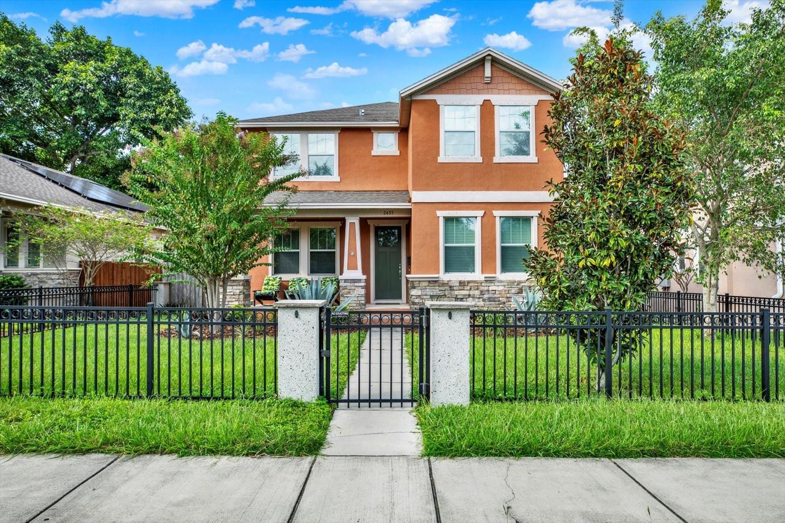 Welcome to this beautifully maintained home in the highly sought-after Kenwood neighborhood. Built in 2016, this residence offers both timeless charm and modern convenience, all just minutes from downtown St. Petersburg.
The inviting front porch and wrought iron fence create excellent curb appeal. Inside, you’ll find wood-look tile floors throughout the main level, decorative baseboards, and arch doorways that add character. An office (or make it a formal dining room!) at the front of the home is filled with natural light, while a spacious guest bedroom sits just across the hall.
The heart of the home is the island kitchen featuring designer granite counters, stainless steel appliances and a pantry that flows seamlessly into the great room. French doors open to a covered lanai overlooking the private, fenced backyard—ideal for entertaining or even adding a pool. A paved walkway leads to the detached garage for added convenience.
Upstairs, the generous primary suite boasts tray ceilings, abundant windows, an oversized walk-in closet, and a spa-like bath with dual vanities, a soaking tub, and a beautifully tiled shower. Two additional bedrooms, another full bath, and a laundry room complete the second floor.
Perfectly located near the Edge District, waterfront parks, museums, and vibrant Downtown dining and festivals, this North Kenwood gem offers both comfort and convenience.