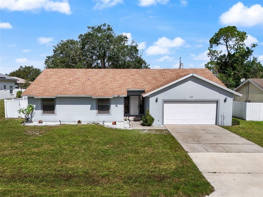 One or more photo(s) has been virtually staged. Welcome to 1580 E Normandy Blvd!!
This lightly lived-in, completely move-in-ready home is ready for its next owner! Offering true peace of mind, the roof was replaced in December 2020, the garage door was updated the same year, and the water heater was installed in 2017. Fresh interior and exterior paint give the home a clean, modern look, while the thoughtful updates and meticulous care throughout make it feel brand-new.
Step inside and you’re immediately greeted by soaring vaulted ceilings that create an open, airy feel throughout the main living area. The spacious family room centers around a beautiful brick-front wood-burning fireplace, adding timeless warmth and character to the space. Large sliding glass doors fill the room with natural light and open to the screened porch, seamlessly blending indoor and outdoor living. Luxury vinyl plank flooring enhances the main living area, stylish, durable, and easy to maintain.
The large, open kitchen is the perfect heart of the home, offering plenty of counter space, a spacious dining area, and stainless-steel appliances including a refrigerator, range, and microwave. Whether you’re hosting a family gathering or a quiet dinner for two, the open layout keeps everyone connected.
The primary suite provides a true retreat with generous proportions, ample natural light, and direct access to the backyard. There’s plenty of closet space, a dressing area with dual sinks, and room to create a cozy sitting or work nook. Three additional bedrooms give you the flexibility for guests, a home office, or hobbies- each comfortably sized and bright.
Step outside to enjoy the best of the Florida lifestyle. A screened-in back porch overlooks the fully fenced backyard, offering privacy, shade, and room to play. The yard is dotted with mature oak trees and features a beautiful pergola on a concrete slab- ideal for outdoor dining, barbecues, or simply relaxing under the stars. The lot’s size provides ample space for a garden, play area, or even a future pool.
Located in an established Deltona neighborhood with no HOA, this property offers freedom and space while remaining close to everyday conveniences. Conveniently situated near I-4, you’ll enjoy an easy commute into Orlando for work or entertainment and a quick drive up to Daytona Beach or New Smyrna for a day by the water.
Lightly lived in and never rented, this home has been lovingly maintained as a seasonal residence and shows true pride of ownership. With its open floor plan, vaulted ceilings, fireplace charm, and outdoor living potential, 1580 E Normandy Blvd delivers comfort, functionality, and value all in one package.
Homes this clean and move-in ready on private, fenced lots rarely come available, schedule your private showing today and make this one yours!
