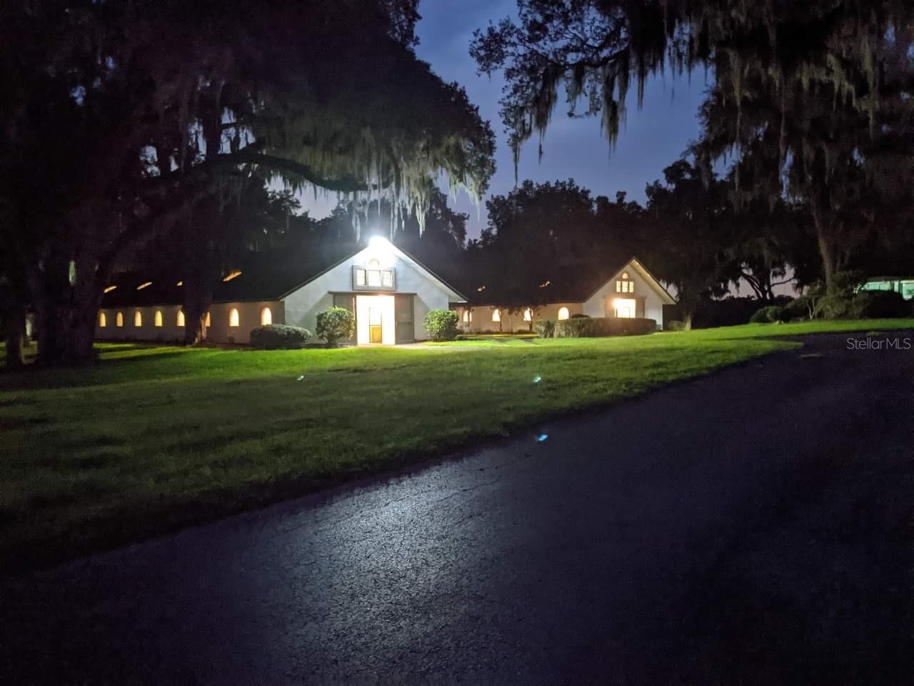 This 73+ acre farm features one of the most beautiful elevations in all of Marion County! Are you dreaming of a life surrounded by nature, luxury, and top-tier equestrian facilities? Imagine waking up to the serene sounds of sandhill cranes and the sight of rolling hills adorned with numerous majestic oak trees overlooking your own private spring-fed lake, providing a tranquil canvas for your equestrian dream farm. Silverleaf Hills Equestrian Estates, a newly developed, gated community spanning over 768+ acres of breathtaking beauty and this farm is the 2nd largest in the community, adjacent to the Kentucky Derby winning training center McPeek Racing. Nestled in the heart of the community with one of the highest elevations for amazing picturesque views and several premier building sites designed for efficiency and elegance. First-Class Construction: This farm was built with commercial quality infrastructure including roads with underground drainage systems around your primary parcel, ensuring durability and ease of management for your equine operations perfectly laid out for breeding and or show farm use. Four Parcels totaling 73+ acres: 28.55 lake and pastures, 23.06 with 2 barns and 22 paddocks. covered walker and round pen, 10.06 broodmare pasture, 12.04 with riding arena and ready for additional pasture or buildings. "The Twins" - TWO Classic Kentucky style Block Center Aisle Barns with 22 12x12 stalls each for a total of 42 (2 double foaling stalls), newly equipped with LED lighting and have rubber mats and wooden lower walls. The barns mirror each other between a Magnolia lined viewing lane, Multiple tack rooms, a laundry room, office spaces, a break and feed rooms, 2 breeding stocks and storage rooms and each barn equipped with fly systems. The circle drive with unloading side ramp for all rigs makes easy access . Features 19 covered paddocks with oversized three sided shelters built with steel and on concrete/clay base, with 5 board and no climb fencing and auto waters. 100 x 200 outdoor arena, round pen and a 6-horse walker within a covered building. Oversized well and 50 amp RV hookup with its down dedicated septic. Bring your own builder and create the ultimate Equestrian masterpiece.