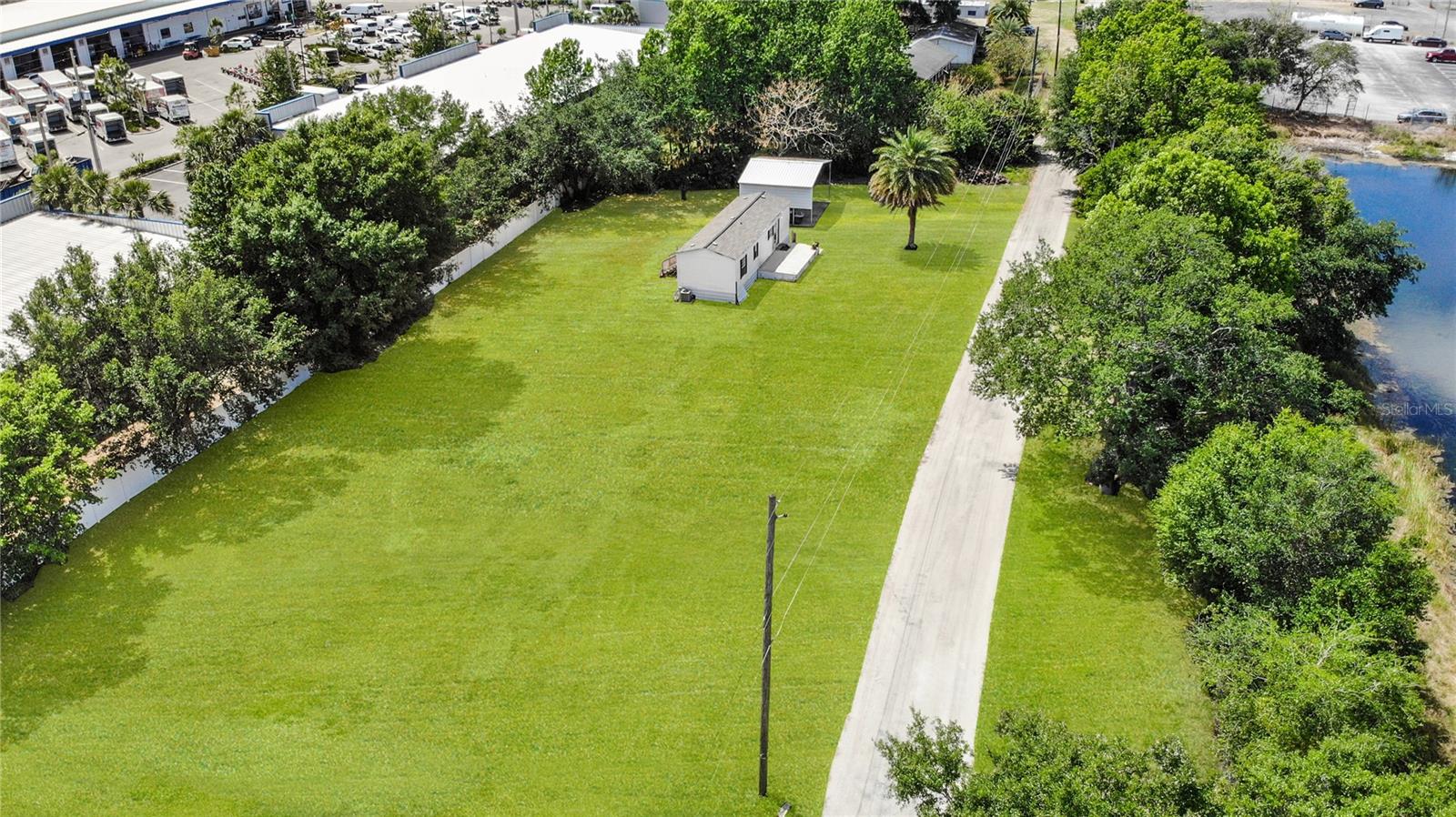 Up to 1.3 acres of industrial land available for lease, with the option to divide into smaller parcels of approximately 0.4 acres each. The featured center lot is 0.44 acres and has electric, septic, and water connections. The property will be cleared of all vegetation and filled with dirt and millings, creating a stable surface ideal for contractors needing space for heavy equipment, containers, service trucks, or trailers.
The main center lot 8292 is approximately 0.44 acres, currently being prepared for heavy-duty use. It includes a 3-bedroom, 1-bath stilt house that can serve as an office or on-site dwelling. This lot is available for $3,000/month and has no history of flooding during rainy seasons.
Located to the north, 8238 Narcoossee Rd is approximately 0.4 acres and includes a 1,040 sq ft building. It’s well-suited for storage, operations, or office use, and is offered at $3,000/month.
To the south, 8304 Narcoossee Rd is also about 0.4 acres, featuring a 588 sq ft building and a carport, offering flexible use potential. This lot is available for $3,500/month.
All parcels are conveniently located within 15 minutes of Orlando International Airport (MCO) and adjacent to major highways. These properties are not suitable for trucking operations, mechanical work, or any hazardous uses that may lead to contamination.
For more information or to schedule a showing, contact the listing agent directly.