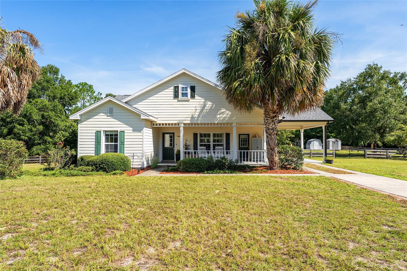 Welcome to Your Spring Ridge Retreat! This stylish 3BR/2BA home sits on 1.24 acres just over the Gilchrist County line—giving you the best of both worlds: quiet country living and lower taxes. The cozy front porch is perfect for morning coffee or rocking chairs, and inside you’ll find a light-filled, open layout with ceramic tile throughout. The kitchen features painted wood cabinets, a newer fridge, durable Avonite counters, built-in pantry shelves, and updated fixtures—all opening to the main living space for easy flow. The large primary suite includes walk-in closets and a beautifully updated bathroom. Recent upgrades keep things fresh, including a new roof (2024), water heater (2023), and thoughtful touches like built-ins, trendy wallpaper, shiplap walls and other modern finishes. Extras include: no HOA, well and septic for lower utility bills, laundry room with washer and dryer, and a one-car carport. The backyard is made for relaxing and entertaining: a covered porch, paver patio, firepit, gazebo, two sheds, and fully fenced yard give you plenty of options to enjoy the outdoors. Just minutes to three gorgeous area springs! And, this home is eligible for a USDA loan, a 0% down payment option.