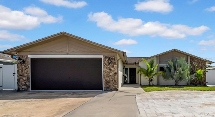 BACK ON MARKET - Buyer got cold feet - their loss is your gain! Welcome to your slice of Florida paradise! This meticulously updated 3BR/3BA home blends modern comfort with resort-style living in prime Largo. This home had no flooding during last year's storms. With no HOA, a brand-new AC in 2024, basically maintenace-free yard, and a long list of additional upgrades, this home is truly move-in ready for its next owner.

The gourmet kitchen features premium finishes and a built-in wine fridge, perfect for keeping the party going. An open layout connects the kitchen to the living room, where vaulted ceilings create an airy, inviting space for gatherings. A versatile flex room with a peek-through to the kitchen can serve as a dining room, home office, or whatever suits your lifestyle. Smart lighting is featured throughout to create the perfect ambiance for every occasion.

The primary bedroom is its own retreat with a walk-in closet, private walk-out access to the pool, and a stylish en-suite bath with a tile shower. Two additional bedrooms and a well-maintained bathroom round out the home.

Step outside to your private oasis with a sparkling saltwater pool heated by solar, an outdoor bar made for weekend gatherings, and turf that stays flawless without a mower in sight. The highlight is a full outdoor bathroom. Not a tiny poolside stall, but a complete setup that impresses guests and saves your floors from wet footprints.

The property is loaded with extras: electric car charging station, RV parking with a 50-amp hookup, and a double gate with room for boat or jet ski parking. A lifetime shed in the back, pavers throughout with built-in uplighting, and a circular driveway add even more convenience and style. The garage features a screened enclosure so you can enjoy breezy indoor-outdoor living while keeping mosquitoes at bay.

This home is also set up with smart technology, including light switches, thermostat control, WiFi-enabled garage and screen enclosure, and voice-activated lighting compatible with HomeKit, Alexa, or Google Home. Even the pool heater and pump are automatic, making your oasis as effortless as it is beautiful.

All this in a desirable Largo location with easy access to Gulf beaches, dining, and attractions. The home also has an assumable flood policy for only $700 a year.

Whether you want an Airbnb-ready investment or your own backyard retreat, this home checks the boxes. Schedule your showing today.