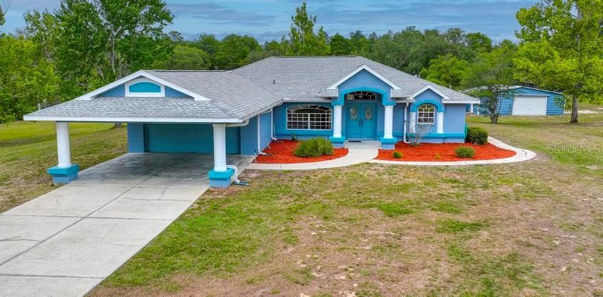 Tucked away on a sprawling 4.83 private acres in Dunnellon, this warm and inviting 3-bedroom, 2-bath home offers the perfect blend of comfort, space, and country charm. Featuring a desirable split floor plan and 1,876 sq ft of living space, the home welcomes you with soaring vaulted ceilings, spacious living areas filled with natural light and an open, airy feel throughout. Step outside to your own backyard retreat with a heated saltwater pool and relaxing hot tub—perfect for entertaining or unwinding under the Florida sky. The property is perfectly suited for agriculture, farming, or hobby livestock, offering endless possibilities for those seeking space to grow and enjoy the rural lifestyle. Car enthusiasts, hobbyists, and outdoor lovers will appreciate the oversized 2-car garage, extended carport, and impressive 900 sq ft workshop with plenty of room for toys, tools, or projects. Peaceful, private, and packed with possibilities, this property is the lifestyle you’ve been waiting for. Conveniently located just twenty minutes from the World Equestrian Center and only ten minutes from Rainbow Springs, Crystal River and downtown Dunnellon. Freshly painted 2026, AC 2020,Roof 2019. No Flood Zone..
