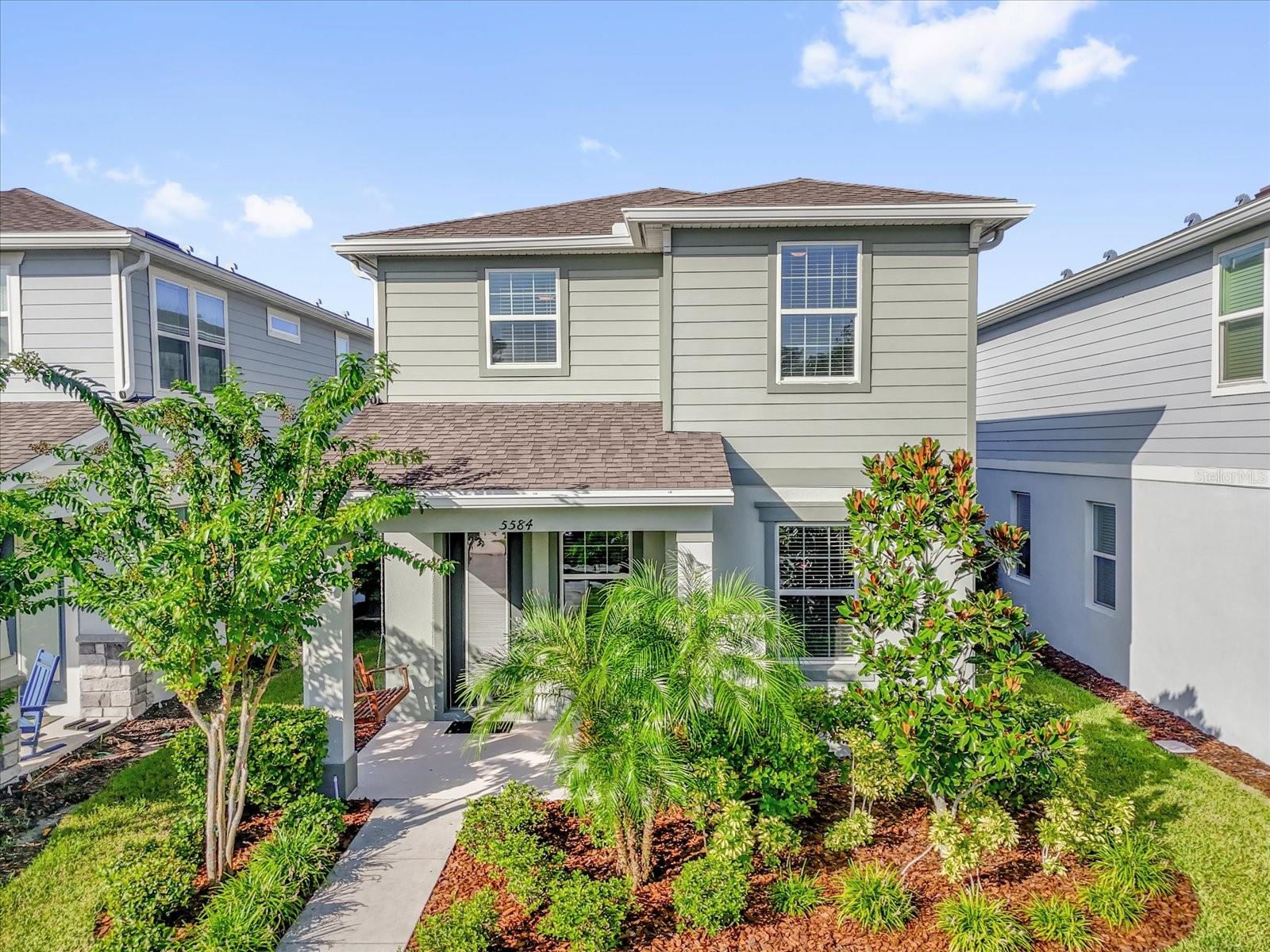 **This house comes with a REDUCED RATE through the seller's preferred lender. This is a lender-paid rate buydown that reduces the buyer's interest rate and monthly payment.** Welcome to a sought-after neighborhood where pride of ownership shows on every street and convenience is at your doorstep. This meticulously maintained two-story home blends thoughtful design with tasteful upgrades throughout, with a beautiful curb appeal accented by a charming front porch, with manicured landscaping around. Step inside to an inviting main level where natural light fills the OPEN LIVING AND DINING AREAS, designed for both relaxing and entertaining. The kitchen is a showpiece with QUARTZ COUNTERTOPS, 42" SOFT-CLOSE CABINETS with roll-out trays, pendant lighting, stylish backsplash, and STAINLESS STEEL APPLIANCES. The microwave is vented outside for convenience, and the island doubles as a prep and gathering space. A FLOOR OUTLET in the living room, along with a TV WALL CHASE and 36-inch MEDIA BOX, make the layout as functional as it is beautiful. Upstairs, the spacious primary suite offers a peaceful retreat with a LARGE WALK-IN CLOSET and an upgraded en-suite featuring DUAL SINKS and ENHANCED TILE finishes. Two additional bedrooms are well-appointed with natural light and Ethernet plugs in each, sharing a tiled full bath. The laundry closet is conveniently located on the second floor. Notable details include SECURITY PRE-WIRING on all windows and doors, 2-INCH FAUX WOOD BLINDS throughout, and a garage pre-plumbed for a FUTURE LAUNDRY SINK. Beyond your doorstep, the COMMUNITY OFFERS A POOL, PLAYGROUND, WALKING TRAILS, and easy access to shopping, dining, parks, and major highways. It’s a rare combination of comfort, convenience, and lifestyle all in one.
