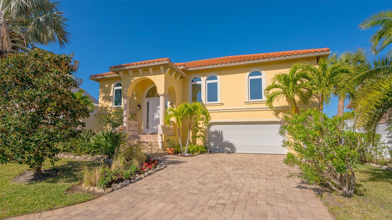 Welcome to this custom home built in 2009. Original owner, two bedrooms plus office or small third bedroom on 120 feet of direct canal access and a short distance to open bay waters and the Gulf beyond. The main living floor features Travertine stairway to an expansive great room, which includes living and dining area and open kitchen. Kitchen boasts maple cabinets, GE Profile, Bosch and Frigidaire appliances. Two bedrooms and 3 full bathrooms plus oversized laundry room, Stiebel Eltron tankless water heater, security system and access to a large covered terrace with Travertine tile all located on main floor. On the lower level is a large storage area as well as an oversized two-car garage with plenty of extra storage and space for a workshop, your recreational water vehicles, or bikes. Multiple doors leading to a large covered patio, outdoor shower, solar heated saltwater pool and 30’ dock with water and electricity and 10,000 lb boat lift. Perfect primary residence, second home or investment property minutes away from beautiful sandy beaches of Longboat Key. Nearby restaurants, amazing parks and close proximity to Anna Maria, Bradenton and Sarasota make this home the perfect choice. Furniture available by separate negotiation.
