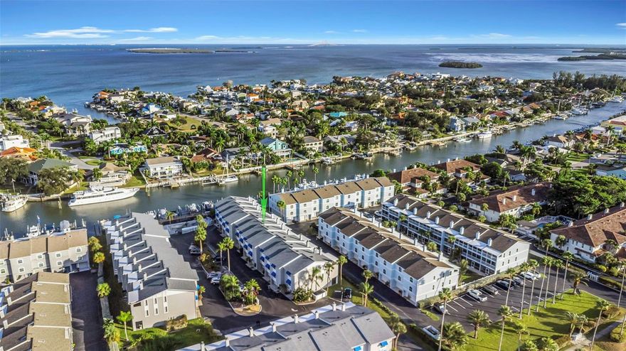 Your Island Paradise Awaits!! Coastal Living on the Water!! Welcome to this beautiful townhome where coastal breezes and effortless living come together in perfect harmony. Located on a peaceful island just minutes from everything, nestled among million-dollar homes and yachts, this stunning residence delivers the lifestyle so many dream about, and now it can be yours!! 

Open-concept layout invites both relaxation and entertaining. The spacious living room features a cozy fireplace and sliding glass doors leading to your private balcony. A generous dining area flows seamlessly into the kitchen, complete with a breakfast bar, center island, and plenty of cabinet space. A convenient half bath on this level adds ideal functionality for guests.

Upstairs, the third floor hosts two comfortable bedrooms, including the primary bedroom with its own private balcony, a peaceful retreat to unwind each evening. The spacious primary bathroom features a relaxing bathtub where you can slip away with your favorite book and enjoy a quiet moment to yourself. The guest bedroom offers convenience and privacy with its own bathroom featuring a walk-in shower.
The laundry is thoughtfully located on the same floor as the bedrooms, making everyday living effortless and efficient.

Downstairs, the spacious garage offers room for your vehicle, storage, and toys, while the BONUS room, not included in the square footage, provides incredible flexibility. Use it as an exercise room, workshop, hobby space, or extra storage. A door leads to a covered patio, perfect for enjoying the shade after a day on the water.

The community has been thoughtfully updated with newer roofs and solar attic fans, helping reduce energy costs and protect your investment. Spend your days lounging at the waterfront pool, with exciting enhancements to the entire pool area coming soon to elevate your coastal experience even more.

All of this is set in an unbeatable location!! Walk to island restaurants, bike to nearby parks, or take a short 5-minute drive to the award-winning Fort De Soto beaches and dog park. You’re also just 10 minutes from vibrant downtown St. Pete, 30 minutes to Tampa International, and 45 minutes to Sarasota.

This is more than a home, it’s a coastal lifestyle, fully ready for you to step in and enjoy.
Imagine the life you could live here.  See… Fall in Love… Make it your own!!!