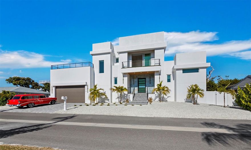 A modern, elevated 2025 masterpiece on fabulous Longboat Key! Built to the utmost of standards by the owners vision for his own family, (he is a also builder), this home has it all. Let’s start with the heavy custom front door surrounded by gorgeous large scale tiles in colors of the sea, that opens to the expansive great room, dining area and huge chefs kitchen. The kitchen is an entertainers dream, with a 5 burner gas range, pot filler, double ovens, built-in microwave and full size side by side refrigerator/freezer. A large center island provides ample storage and incredible work space, and of course there is a walk-in pantry and a separate area for a coffee and a wine fridge. Off of the kitchen and living/dining area is a screened in porch with a full outdoor kitchen for outdoor dining as well as an open porch with steps to the lush green grass. The primary suite is on this level, and a half bath and a gorgeous ensuite. The ensuite features an abundance of light with double sinks, a large double shower and a soaking tub. When you head up the staircase to the 2nd level, you will certainly notice the continuance of the incredible finishes and modern original light fixtures! Here you find a large landing with sliders to the enticing outdoor deck, perfect for your morning workout overlooking the beautiful neighborhood or just a spot for some sunset sky watching or midnight stars. 3 bedrooms, two with a jack and jill and one with a full ensuite make easy use of the space for all of your family and friends. Room for a pool on the side yard, plus deeded beach access across Gulf of Mexico Drive, make this a contemporary beach house to remember! This special, walkable mid-key location puts multiple dining, shopping and wildlife exploring destinations right at your doorstep, but you also have the opportunity for the world-renowned St.Regis Resort, St. Armands Circle and the cultural epicenter of Downtown Sarasota within a short drive. This is truly a lifestyle worth exploring. Make your private appointment today!