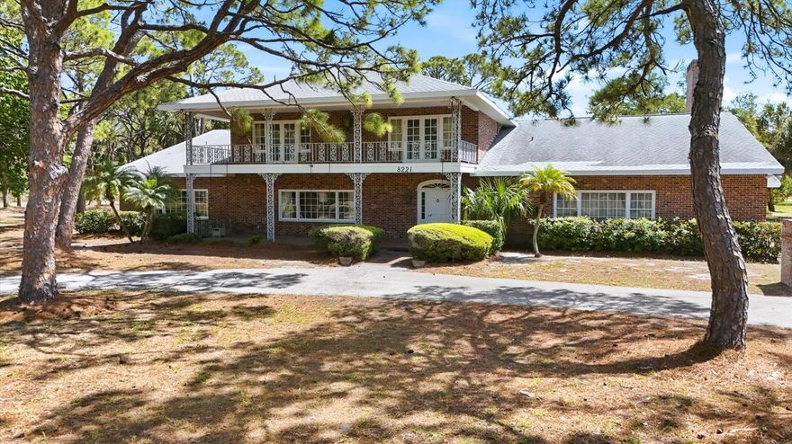 Rare opportunity in NW Bradenton. Stately Colonial Revival/Southern Brick Estate Home surrounded by majestic Oaks, Pines and Palm Trees. All on almost 3.5 acres! Two front porches with custom wrought iron adornments in and out! Special attention to detail include crown molding, wainscotting, tray embellished ceilings, brass doorknobs & hinges imported from England and many lighting fixtures with imported brass. When you enter the front door through the lovely foyer with imported marble floors and decorative niches. Boasting 5745 sf. Under roof, built in the 70’s with great care and intention. Extremely large rooms, Formal Living and separate Formal Dining room that can comfortably it 12 or more. Massive family room large enough to accommodate a pool table with wood burning fireplace. Also, on the first floor there is an office that could also be a bedroom. The Owners Suite has walk-in closets and ensuite featuring marble counters and vanity spaces. Separate laundry room, that can lend to a craft room. The kitchen faces pool area opening out to patio/porch area. It is adjacent to both family and dining rooms. There is walk-in pantry and butler pantry area that can accommodate tablecloths and entertainment supplies. Many closets and plenty of storage throughout the home. A two-story lanai area behind home that leads out to 40 x 20 pool with a two-story pool cage that has been recently replaced. The second floor leads to four bedrooms with extra walk-in storage area and two full baths. Two bedrooms face out to expansive yard with balconies that lead out to porch. Two bedrooms face out to backyard and pool with another balcony that overlooks the pool area and leads down wrought iron spiral staircase. Full house central vacuum. This property is made for family gatherings and entertainment!  Oversized two car garage. All in a park like setting. Many options for this property, bring your imagination! The location is phenomenal. Sought after area of Bradenton adjacent to DeSoto Memorial Park, minutes to famous Anna Maria Beaches. Restaurants and shopping.